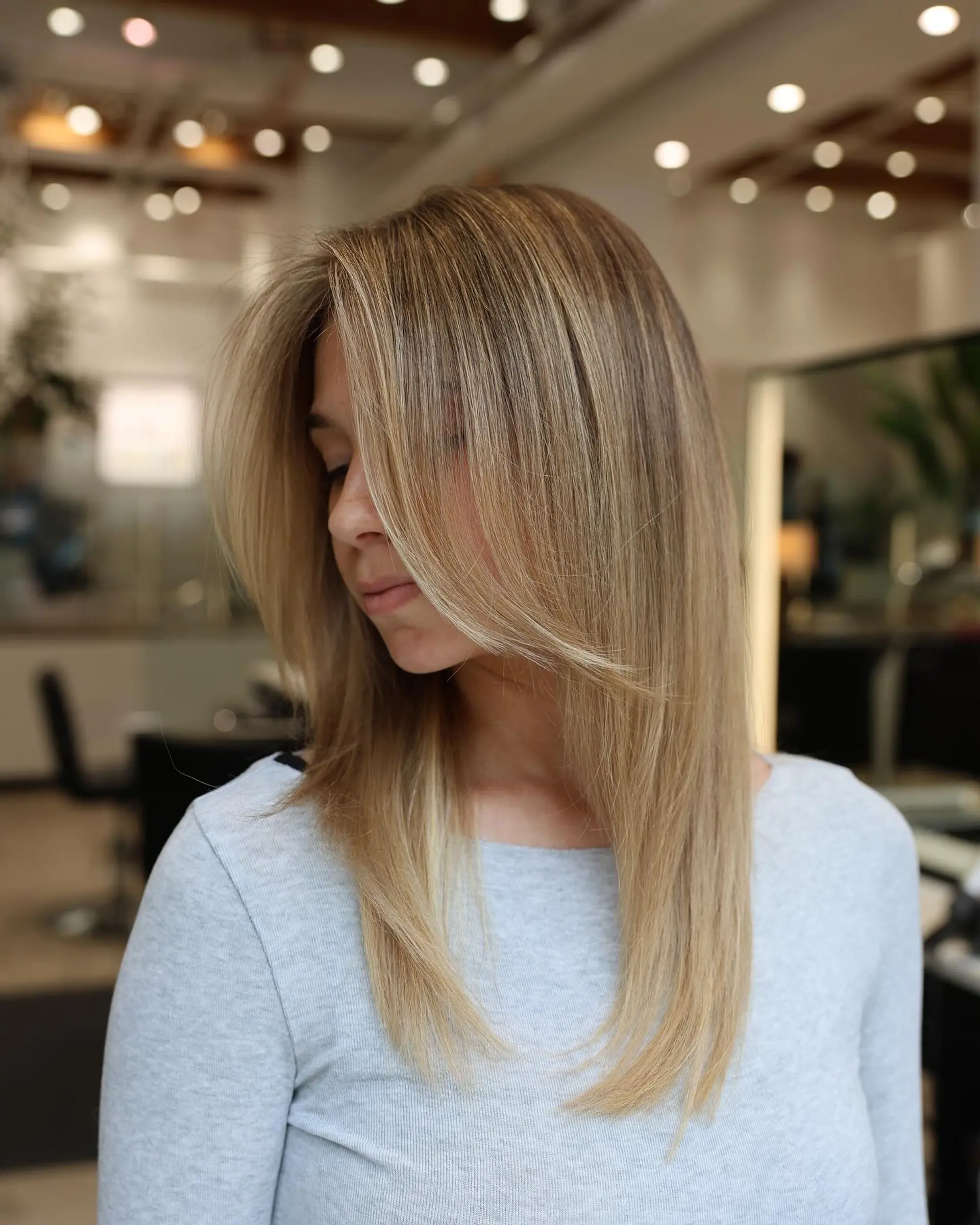 A long layered haircut with face-framing layers for straight hair. 3