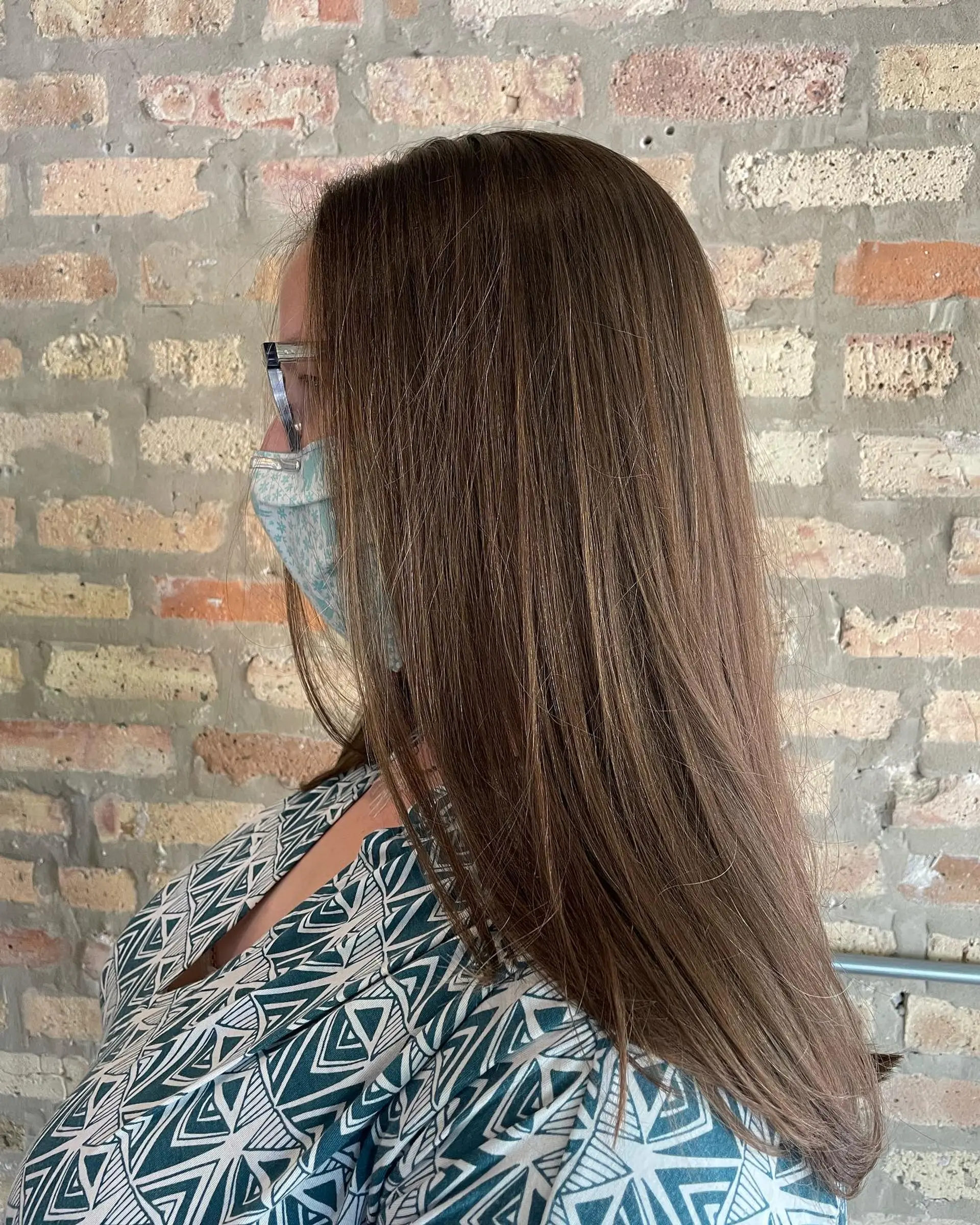 Straight, glossy long brown hair smoothly styled with freshly trimmed ends. 1