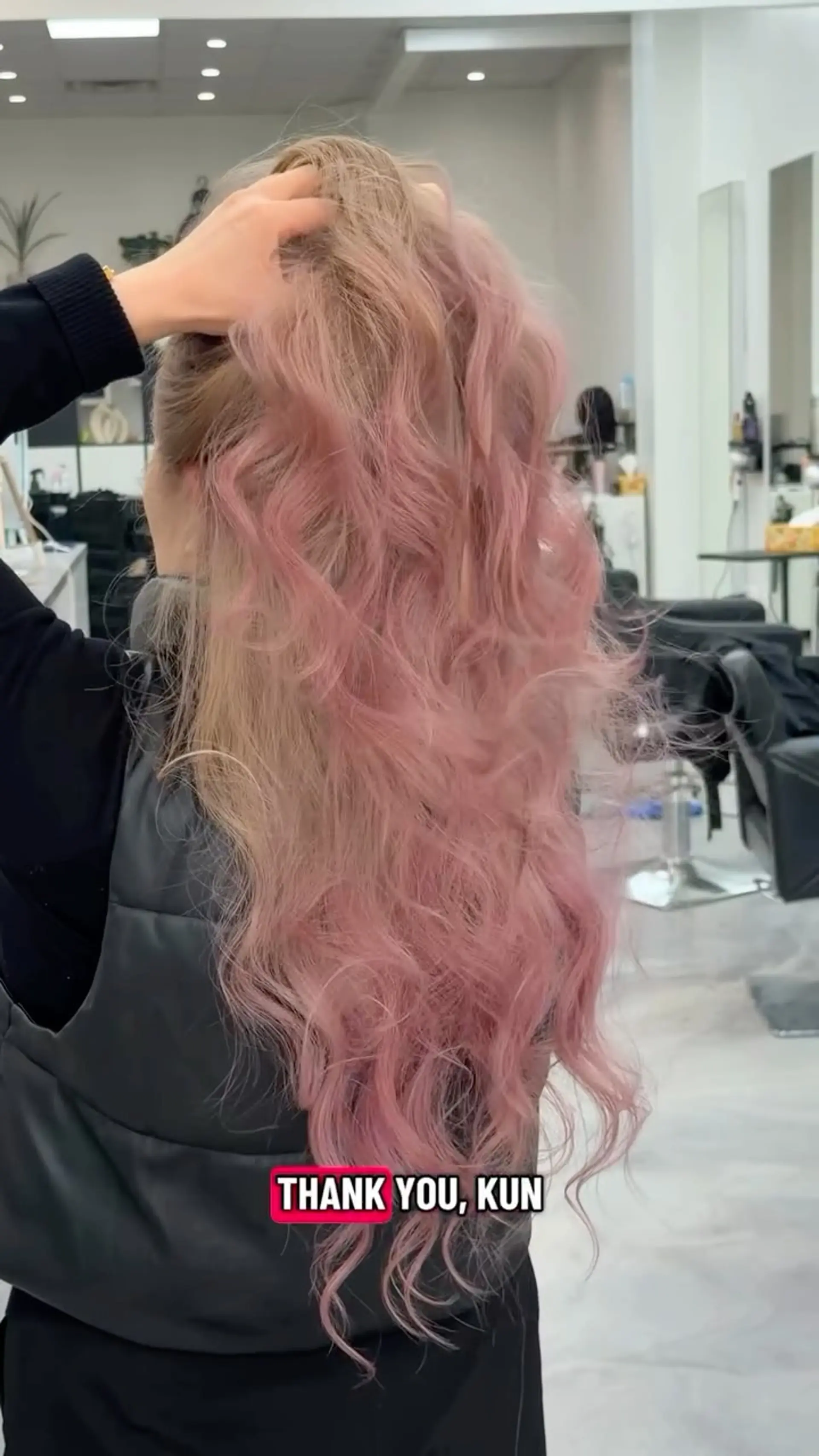 Long cascading waves featuring a soft dusty pink and pastel rose tone over a blonde base. 1