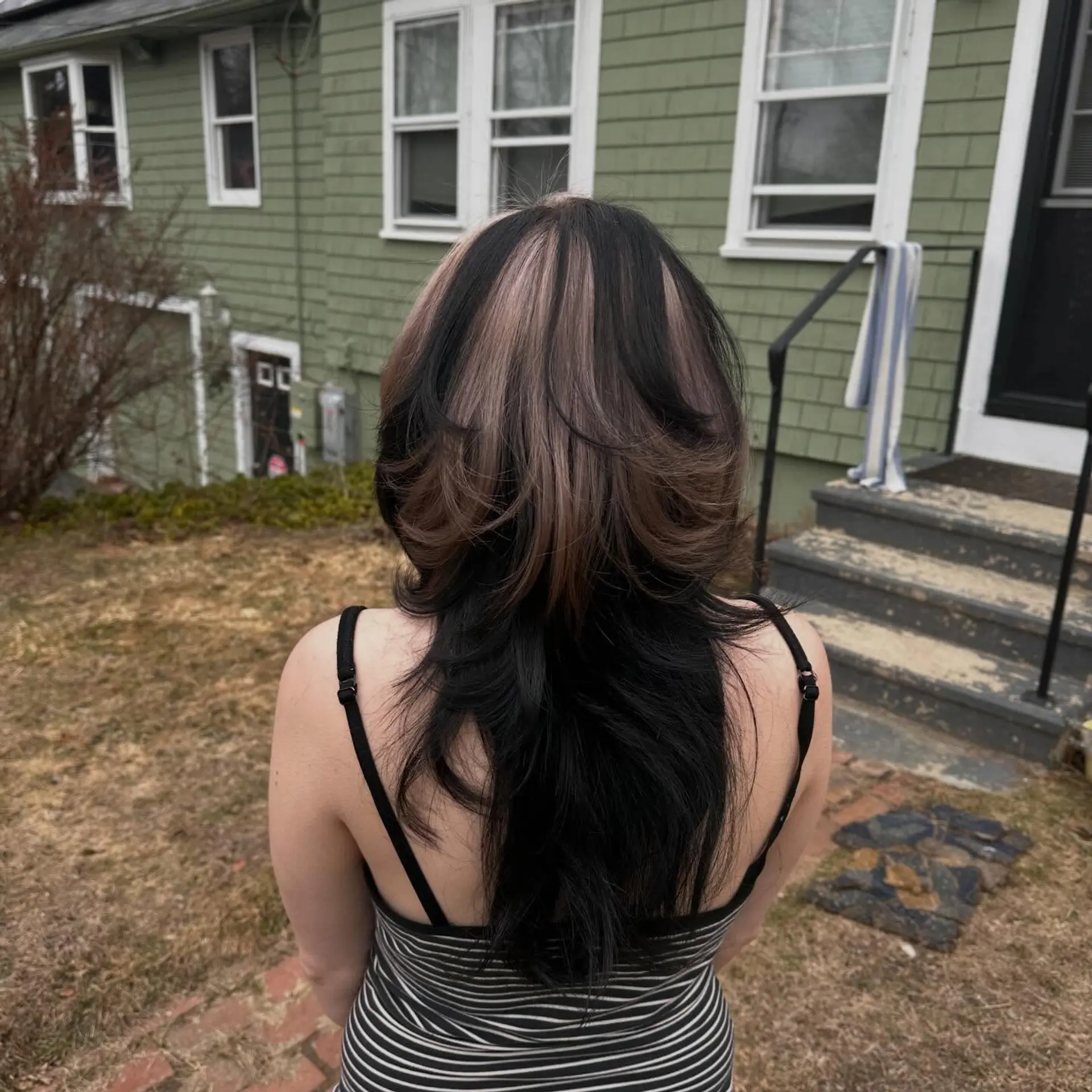 A dramatic jellyfish haircut featuring a rounded, voluminous layered top section over long, cascading lower layers, styled in high-contrast black and ash brown tones. 1
