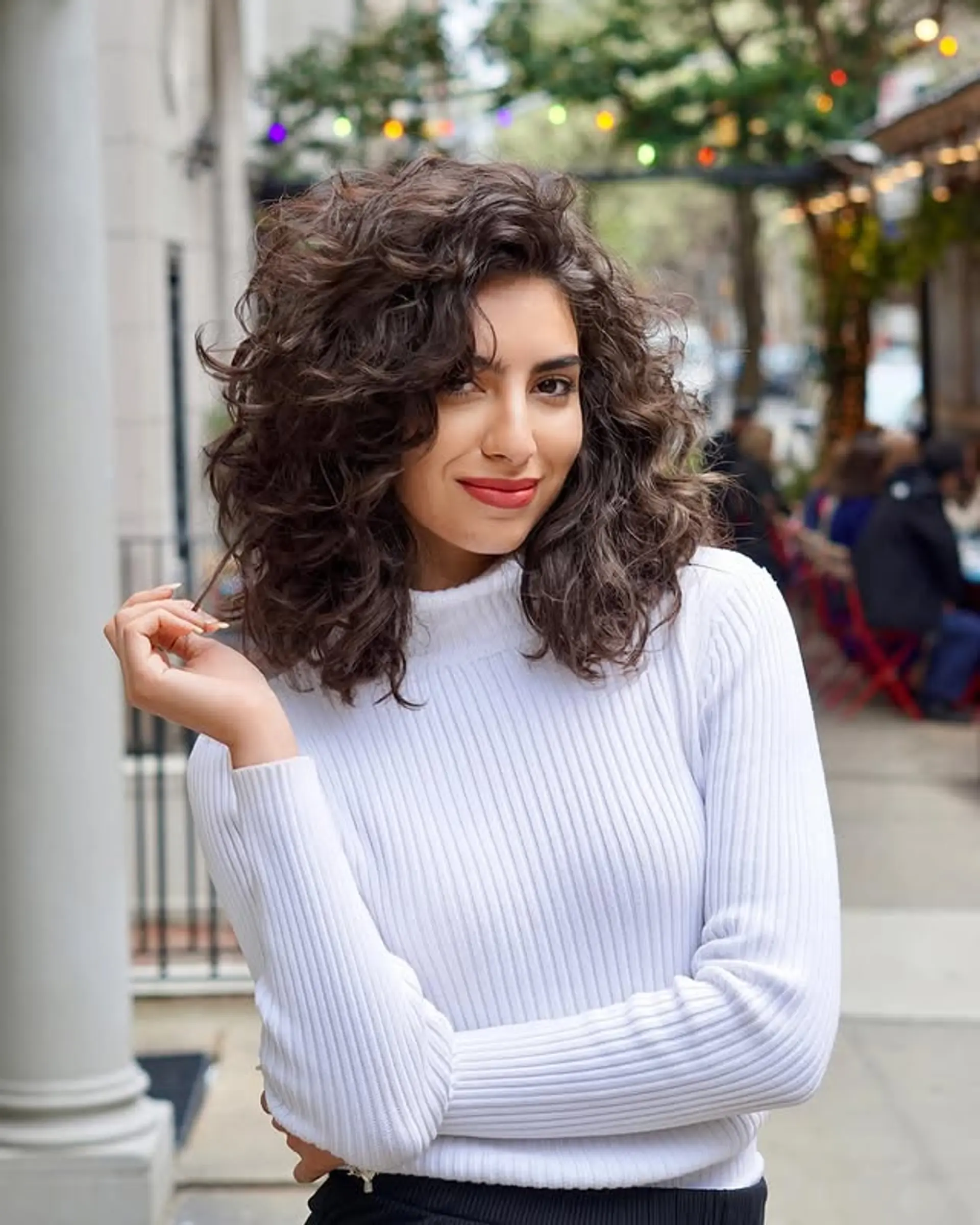 A curly shag with lots of volume and natural curls that fall to the shoulders with layers. 1