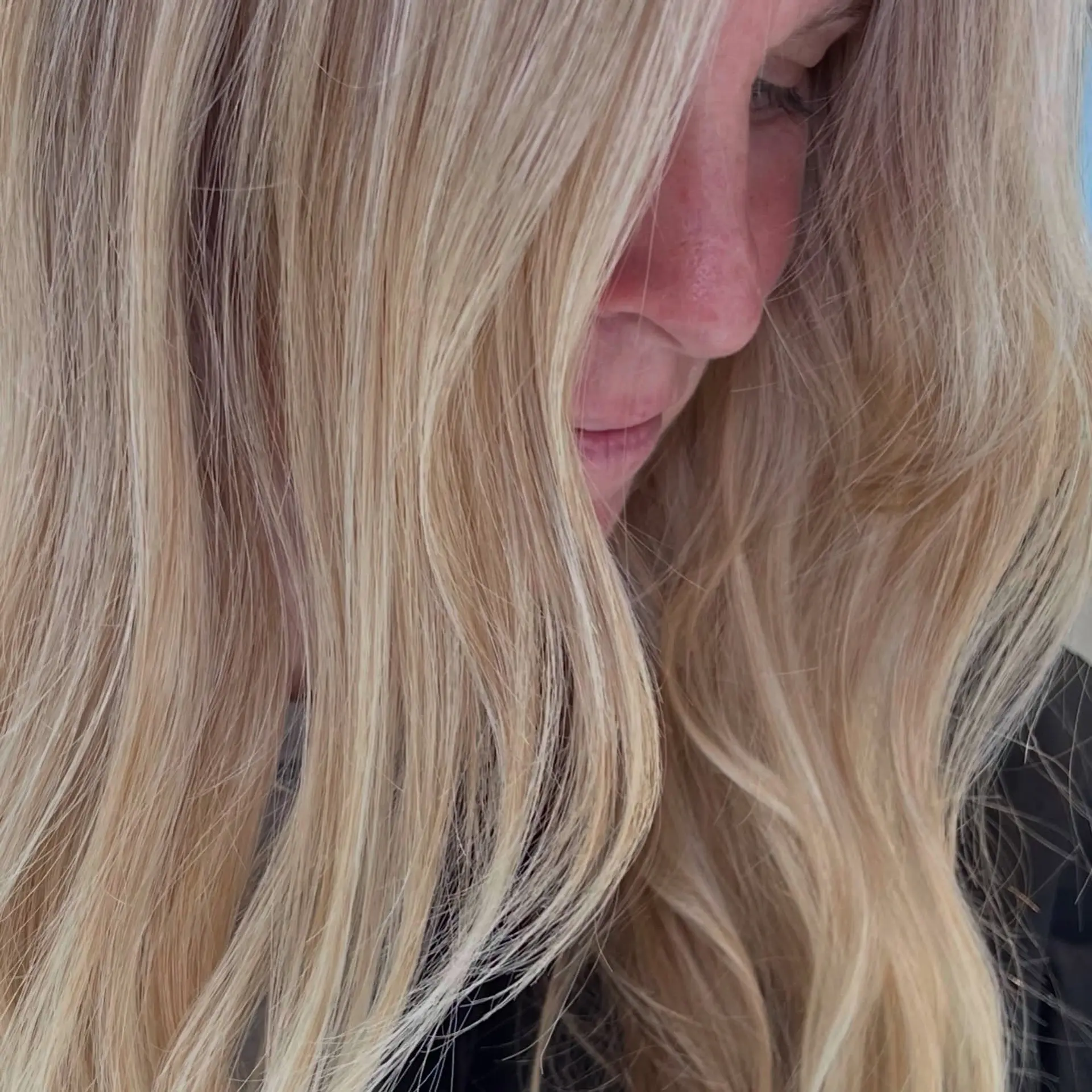 Long dimensional blonde hair styled with soft, natural waves. 1