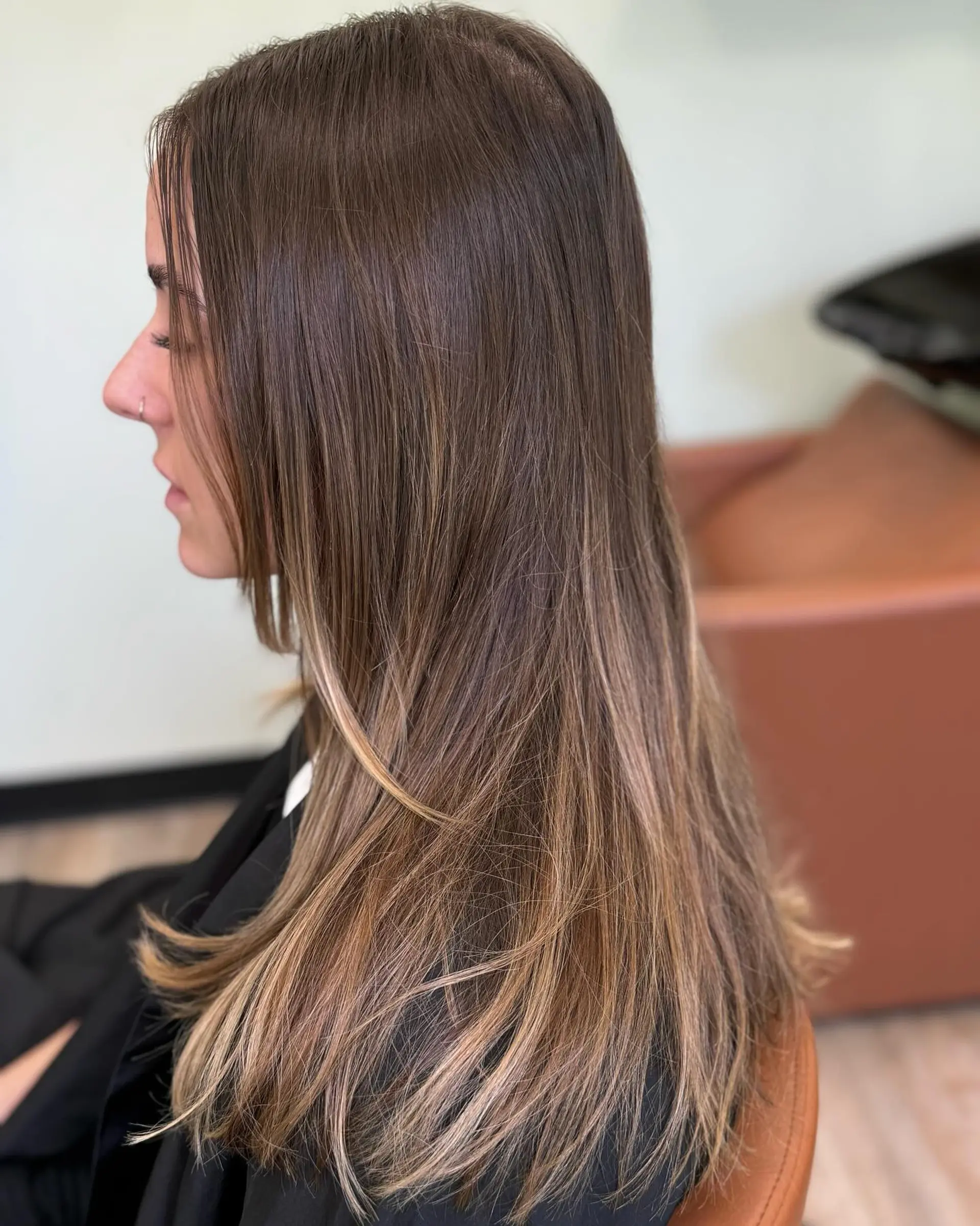 Long straight dark brown hair seamlessly blended with fine caramel and beige blonde balayage highlights. 1