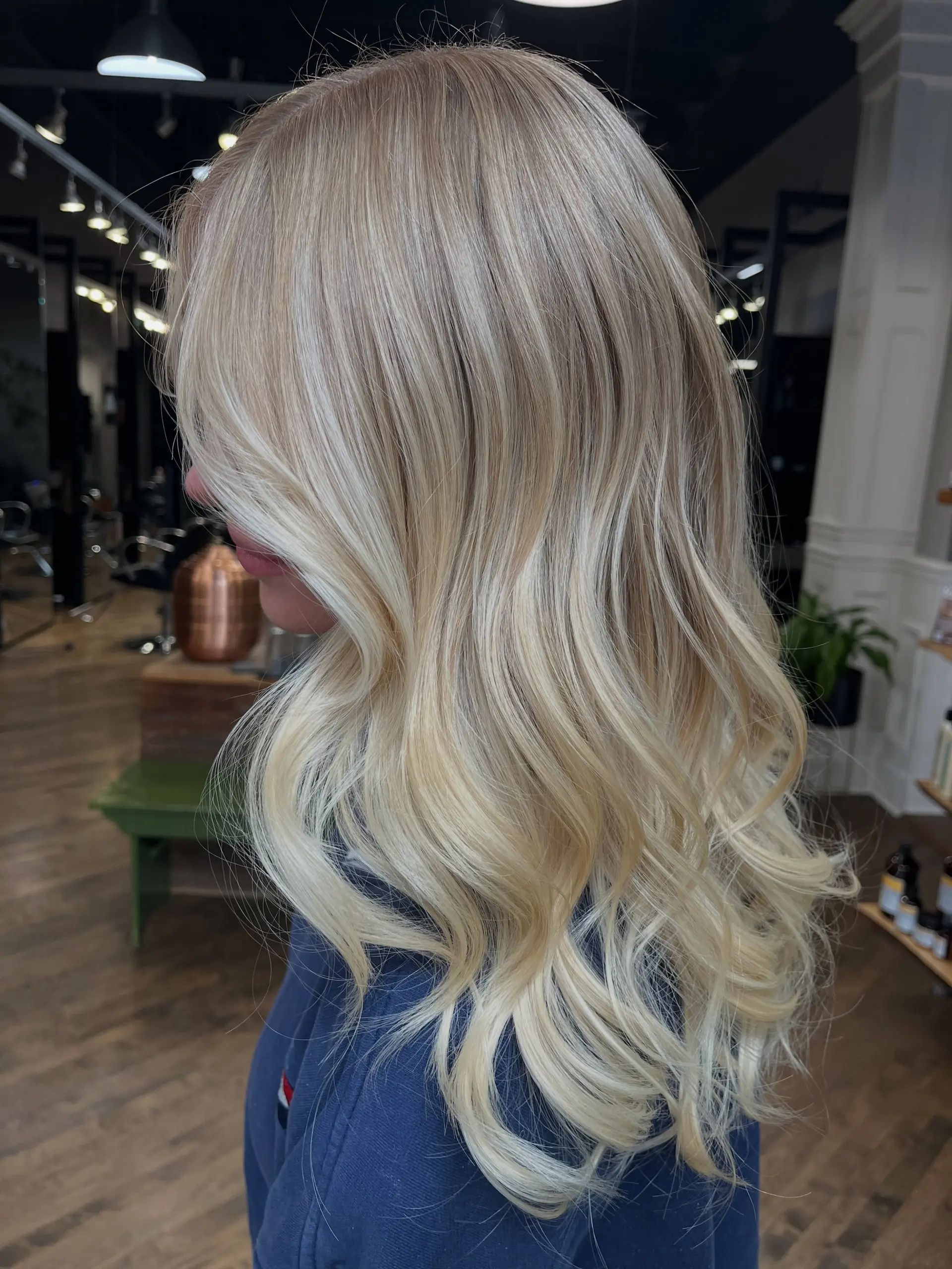 Long luminous blonde hair styled with dimensional highlights and soft, flowing waves. 1