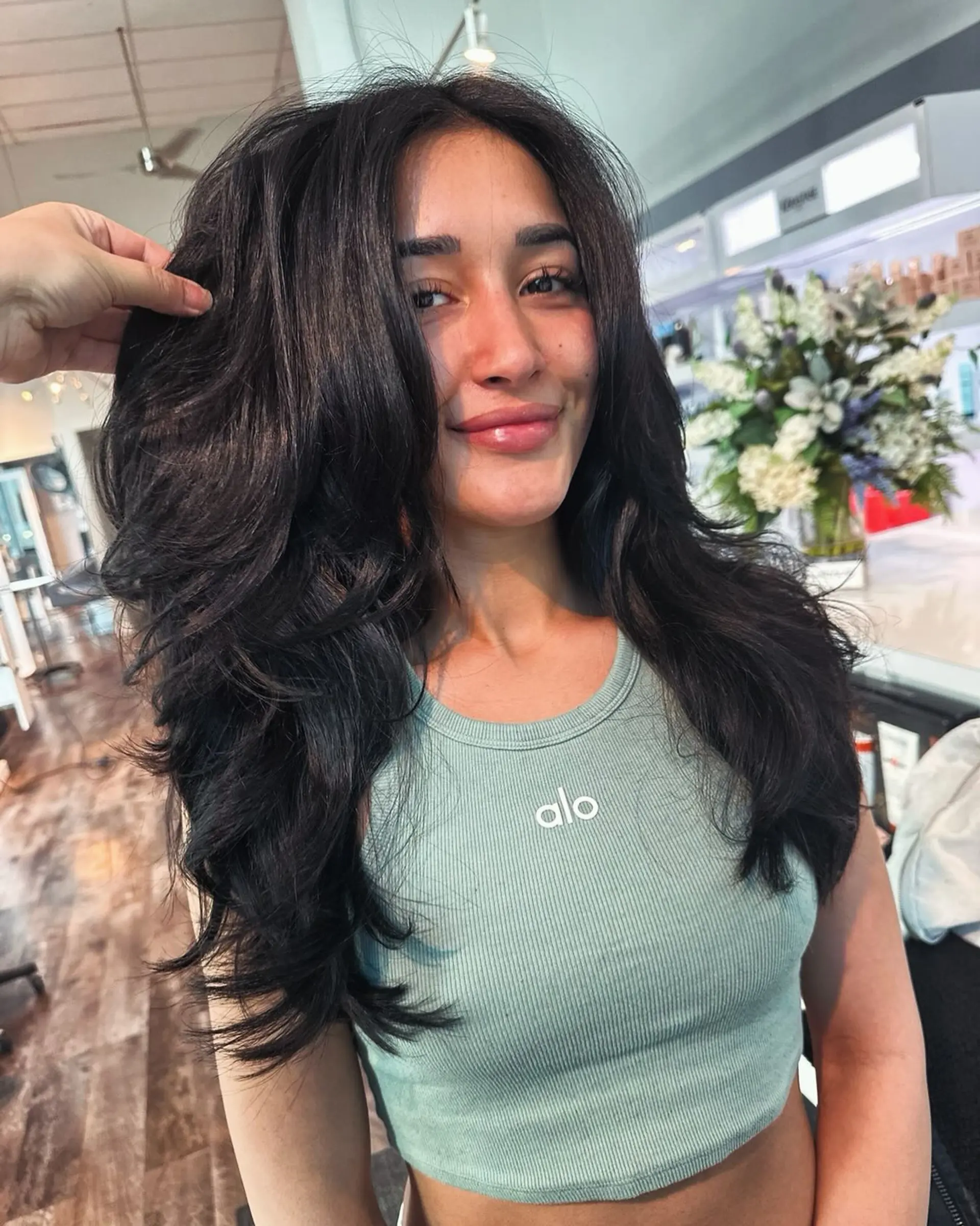 A long, layered haircut with a V-cut and voluminous blowout. 1