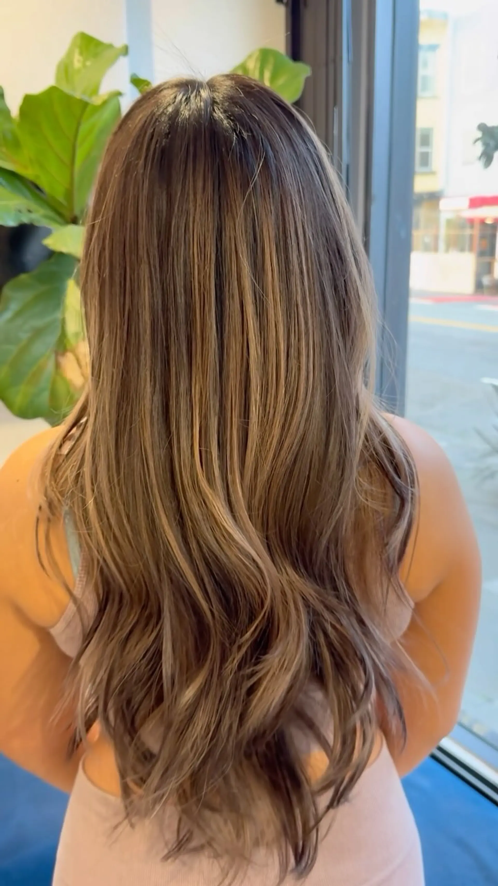 Long cascading waves featuring seamless lived-in blonde balayage with a blended, natural root shadow. 1