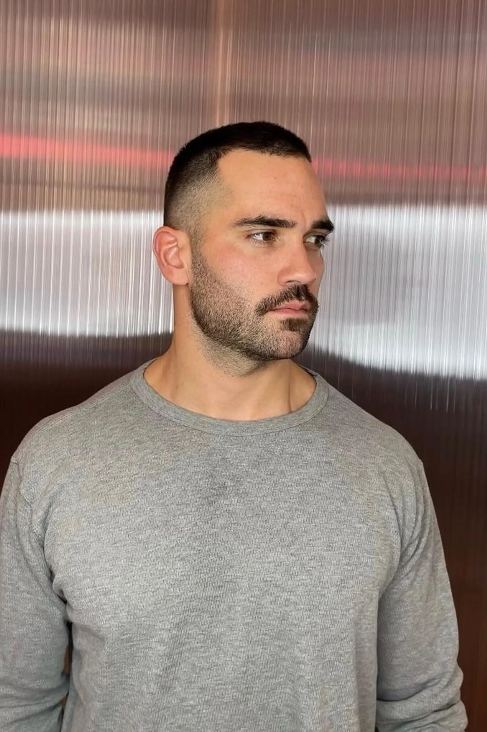 Precision Crew Cut with a high fade and a very short, buzzed, straight top, featuring sharp edges and a minimalist look. The vibe is…. Edgy Clark Kent 🗡️🦸‍♂️