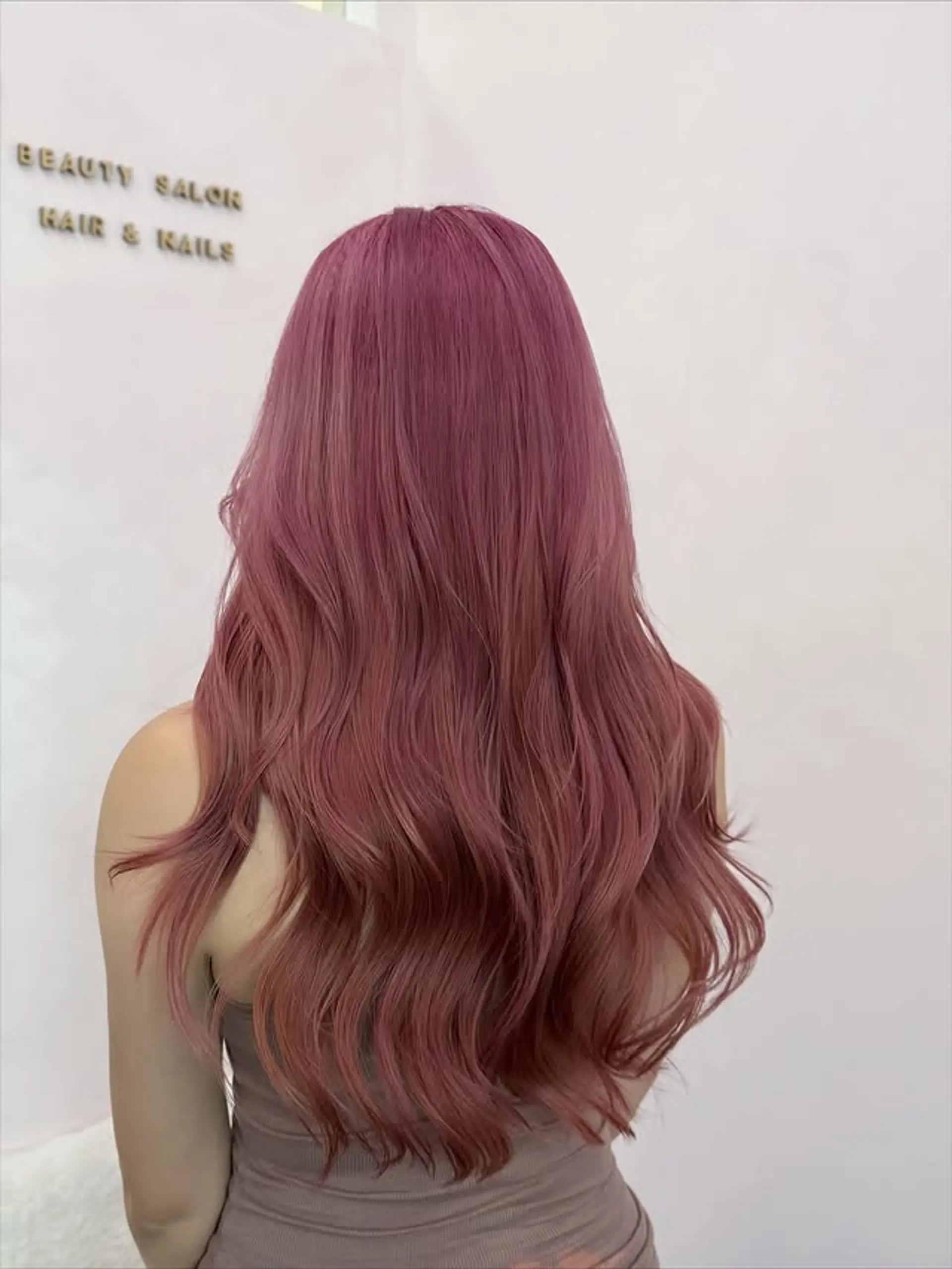 This hairstyle showcases very long, flowing waves with subtle layers that add movement and volume. The hair is styled with soft, loose waves cascading down the back. 1