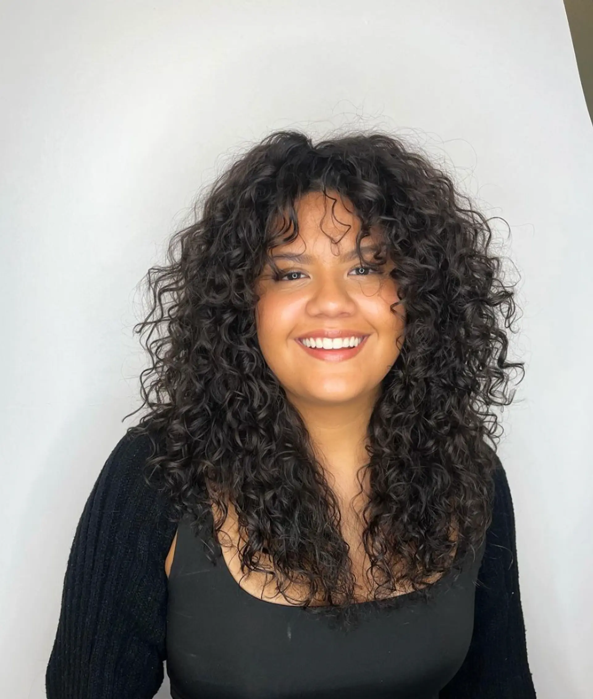 Medium-length hairstyle with voluminous, natural curls and layered, dark brown ringlets.

Cut and style by @juliamannino_hair

 1