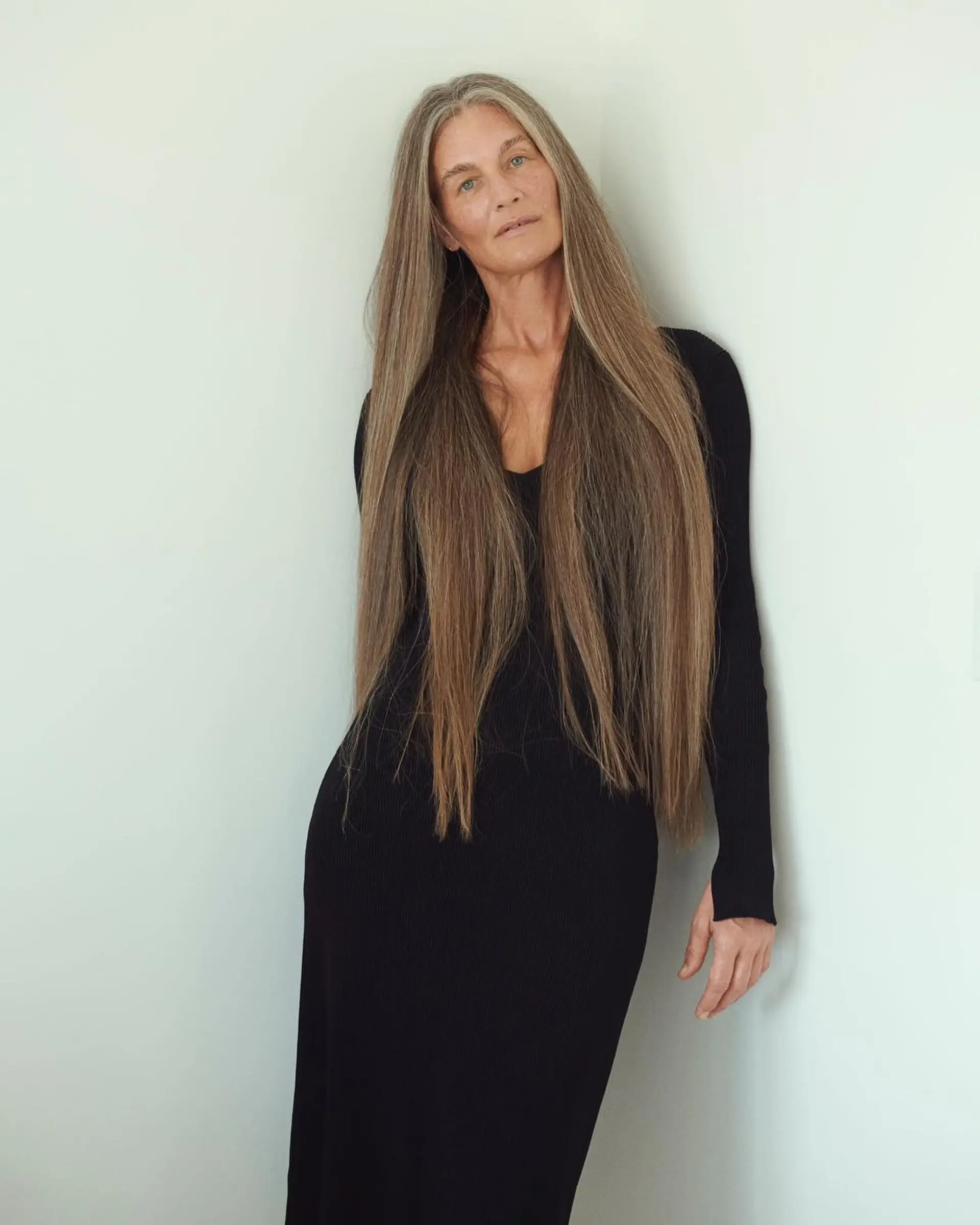 Ultra-long, sleek straight hair in natural silver and cool ash tones worn down with a center part. 1