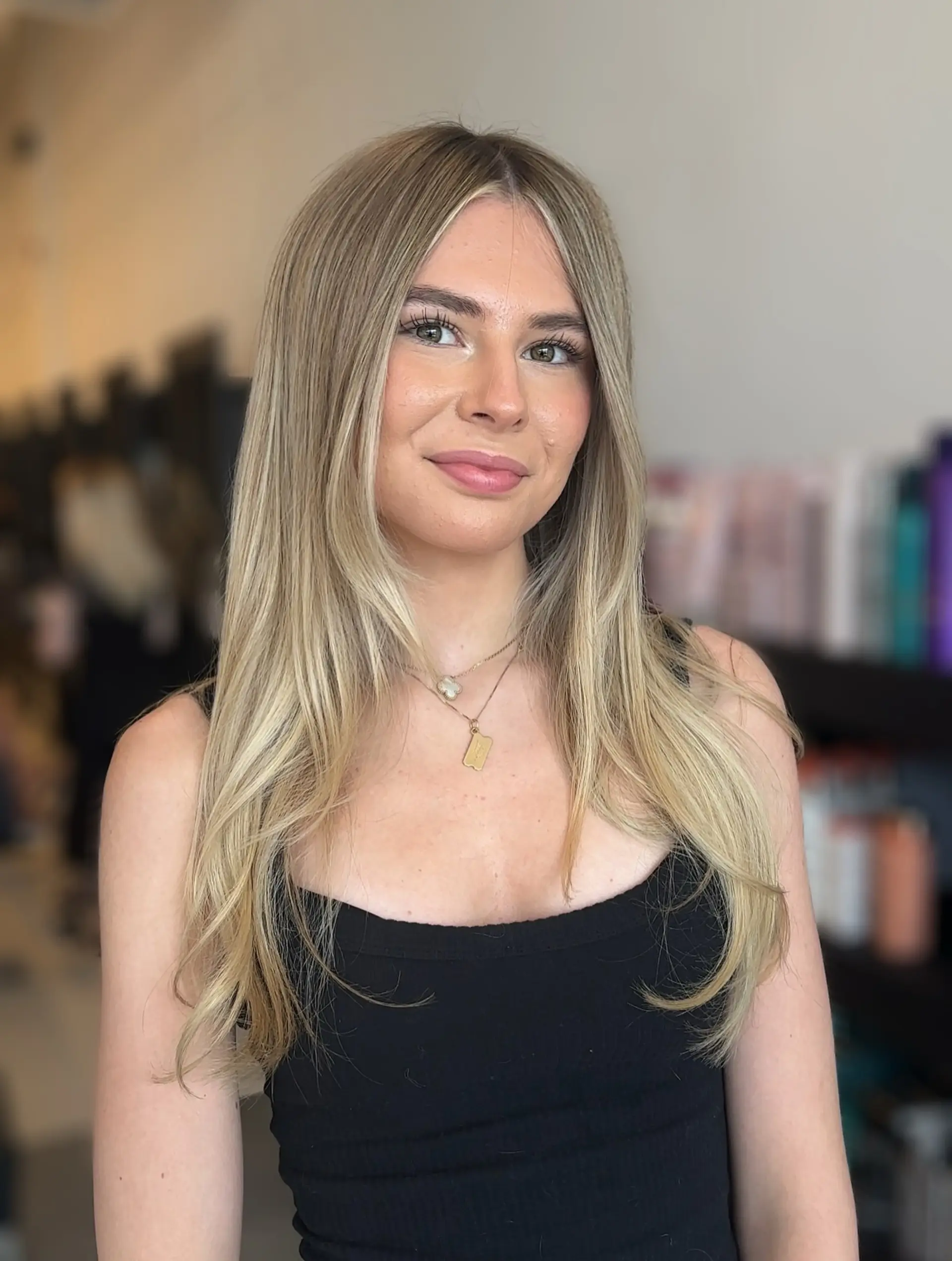 Long ash and beige blonde hair styled with a smooth, straight blowout and softly tapered, face-framing layers. 1