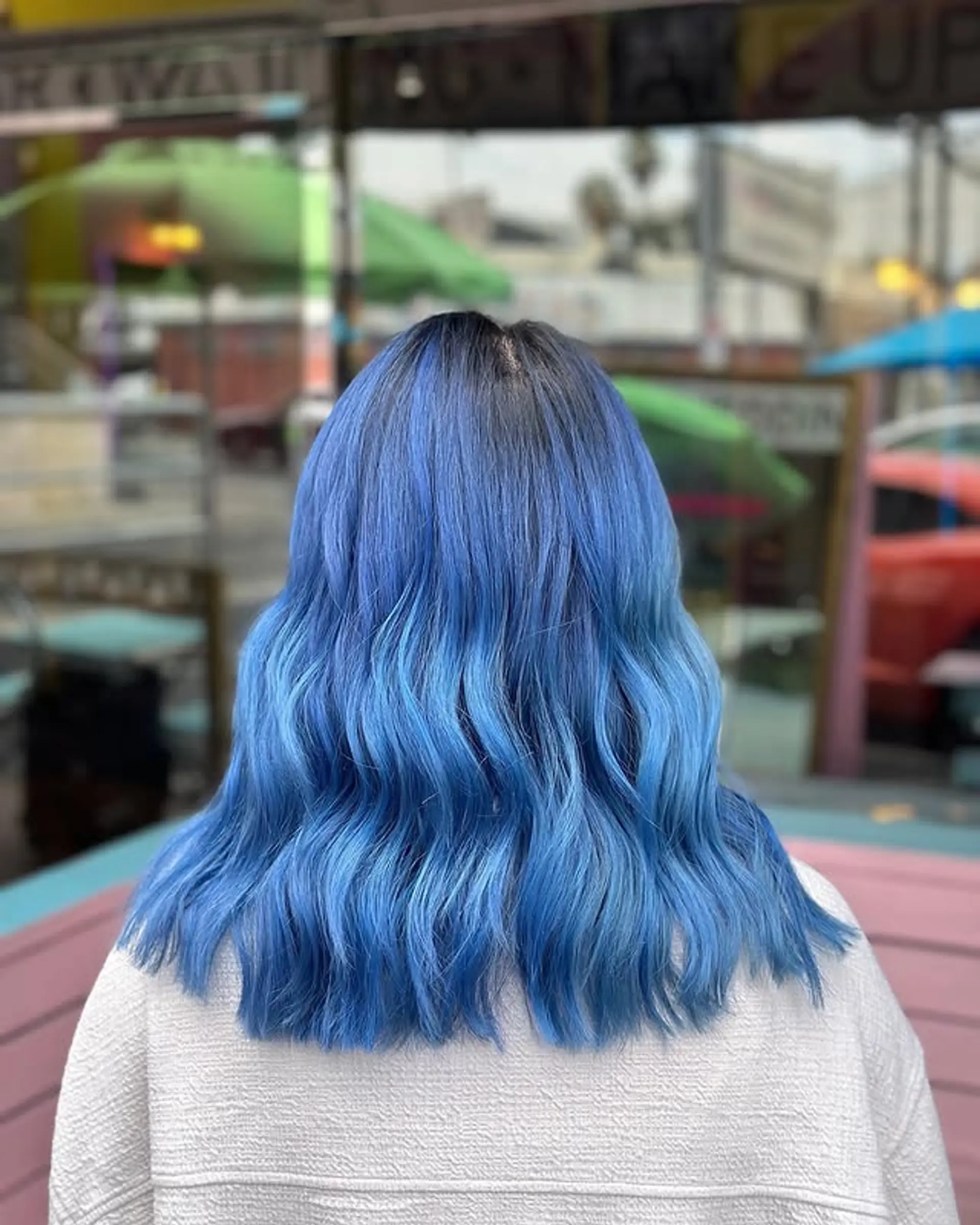 Medium length wavy hair with an ocean blue ombre color melt. 1