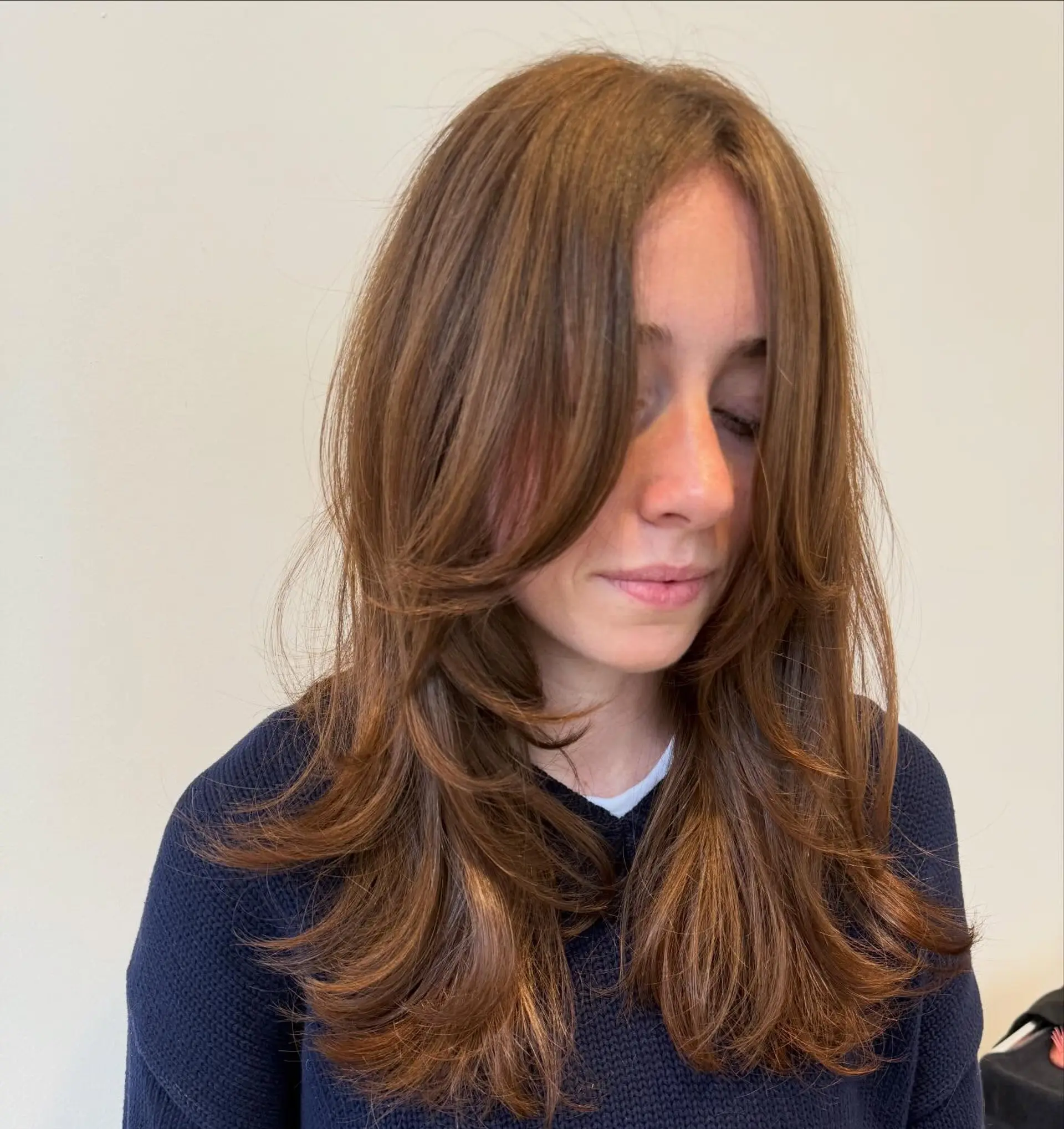 Long brown hair featuring face-framing layers, curtain bangs, and softly flipped ends. 1