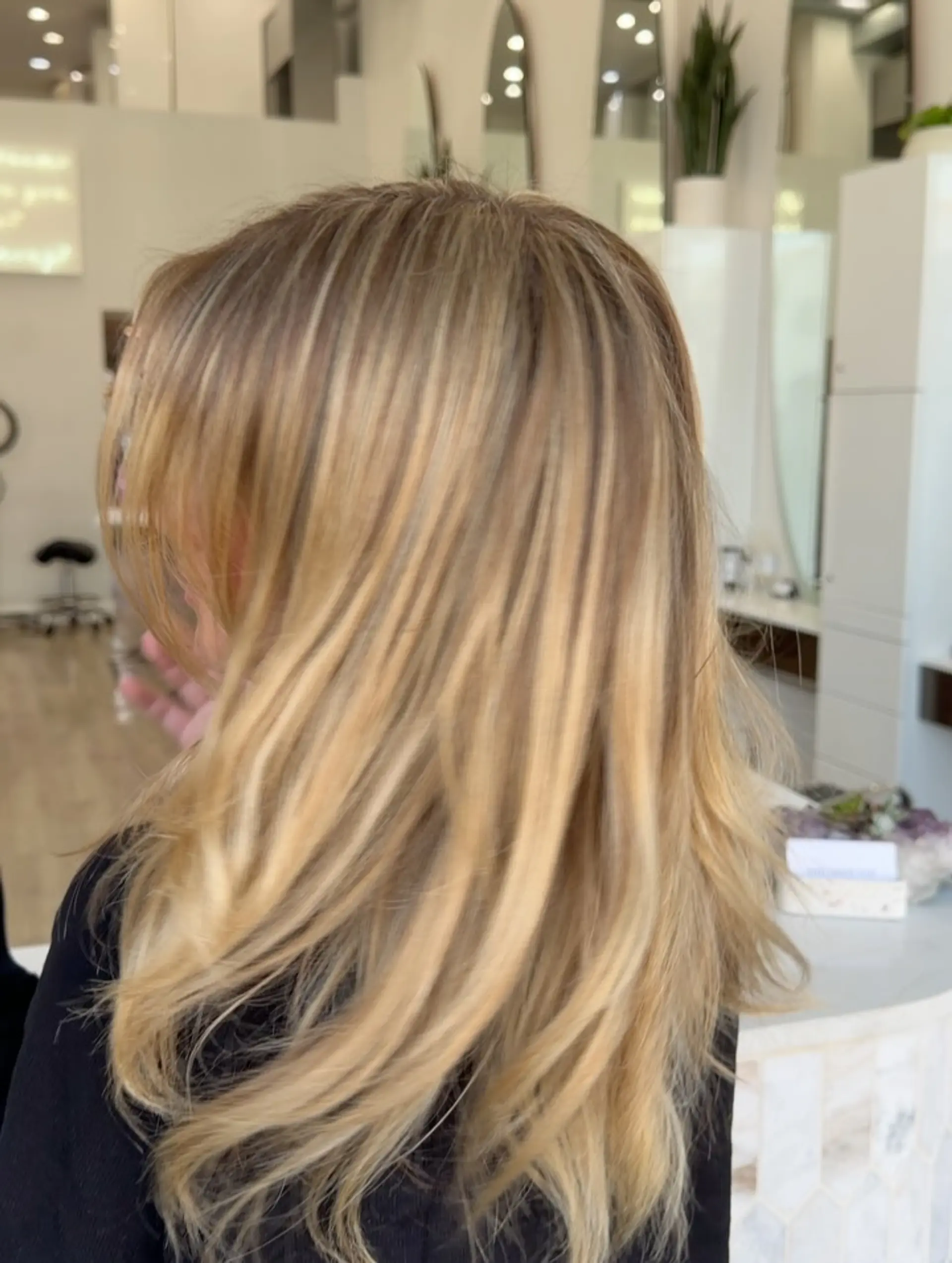 Shoulder-length warm blonde hair featuring fine multi-tonal highlights and soft, blown-out layers. 1