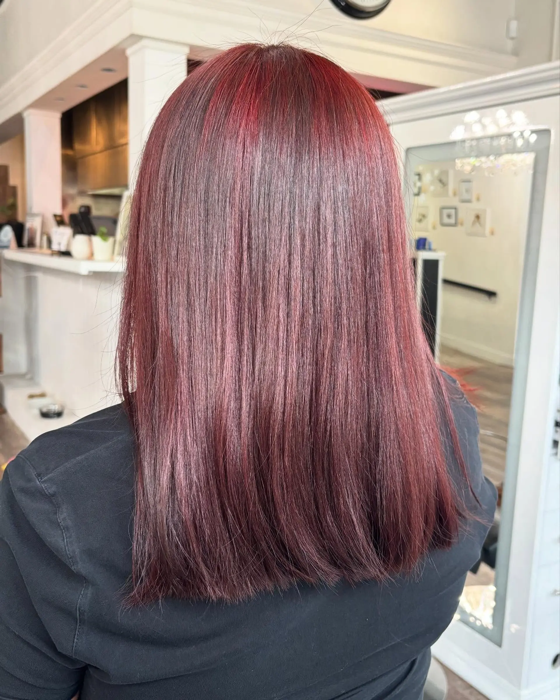 Medium-length straight hair styled with a blunt cut and rich cherry red all-over color. 1