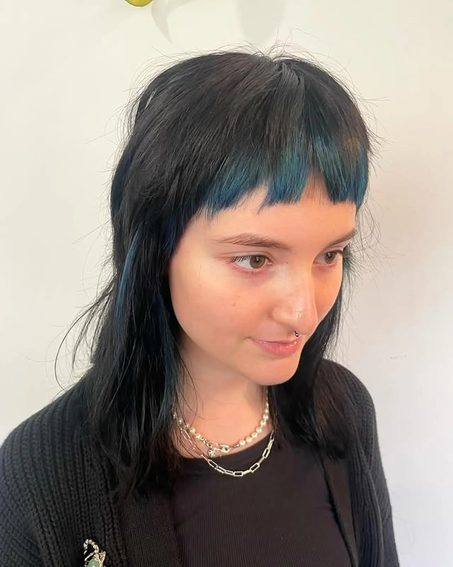 A modern take on the mullet with choppy layers and short, straight bangs. 1