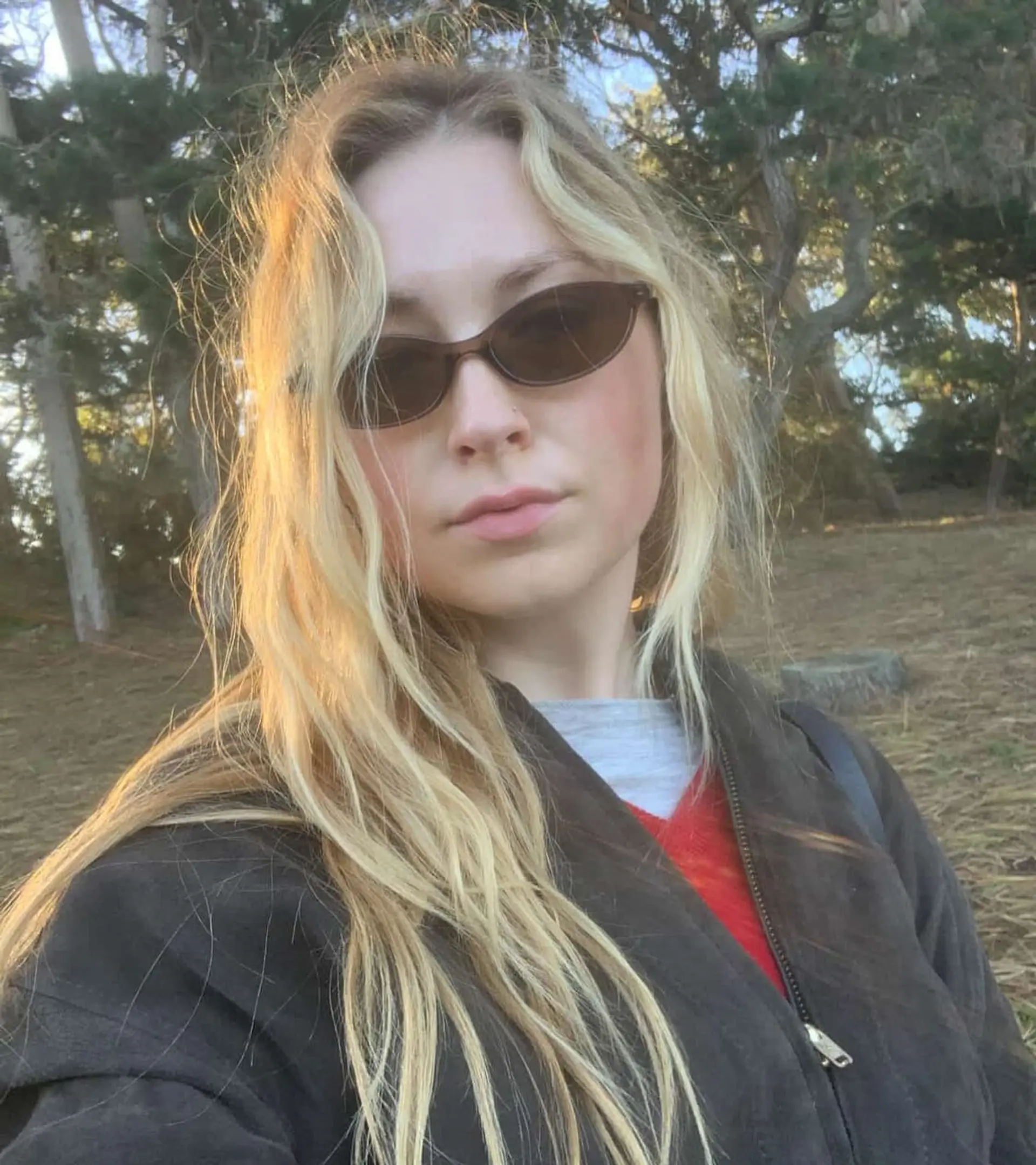 Long blonde hair with soft waves and a natural lived-in grow-out balayage. 1
