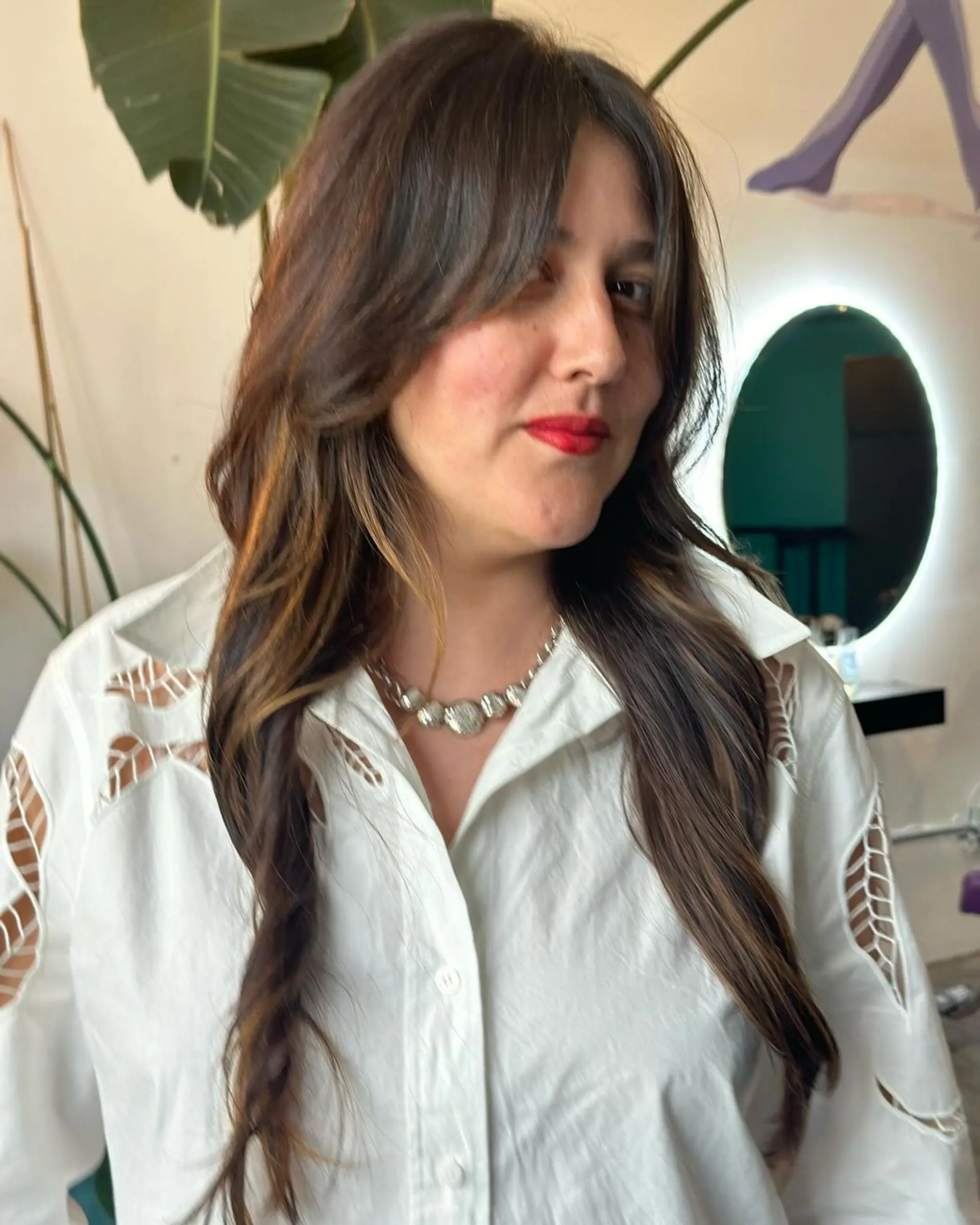 Long, straight hairstyle with soft layers and a side-swept fringe, featuring dark brown color and subtle highlights. 2