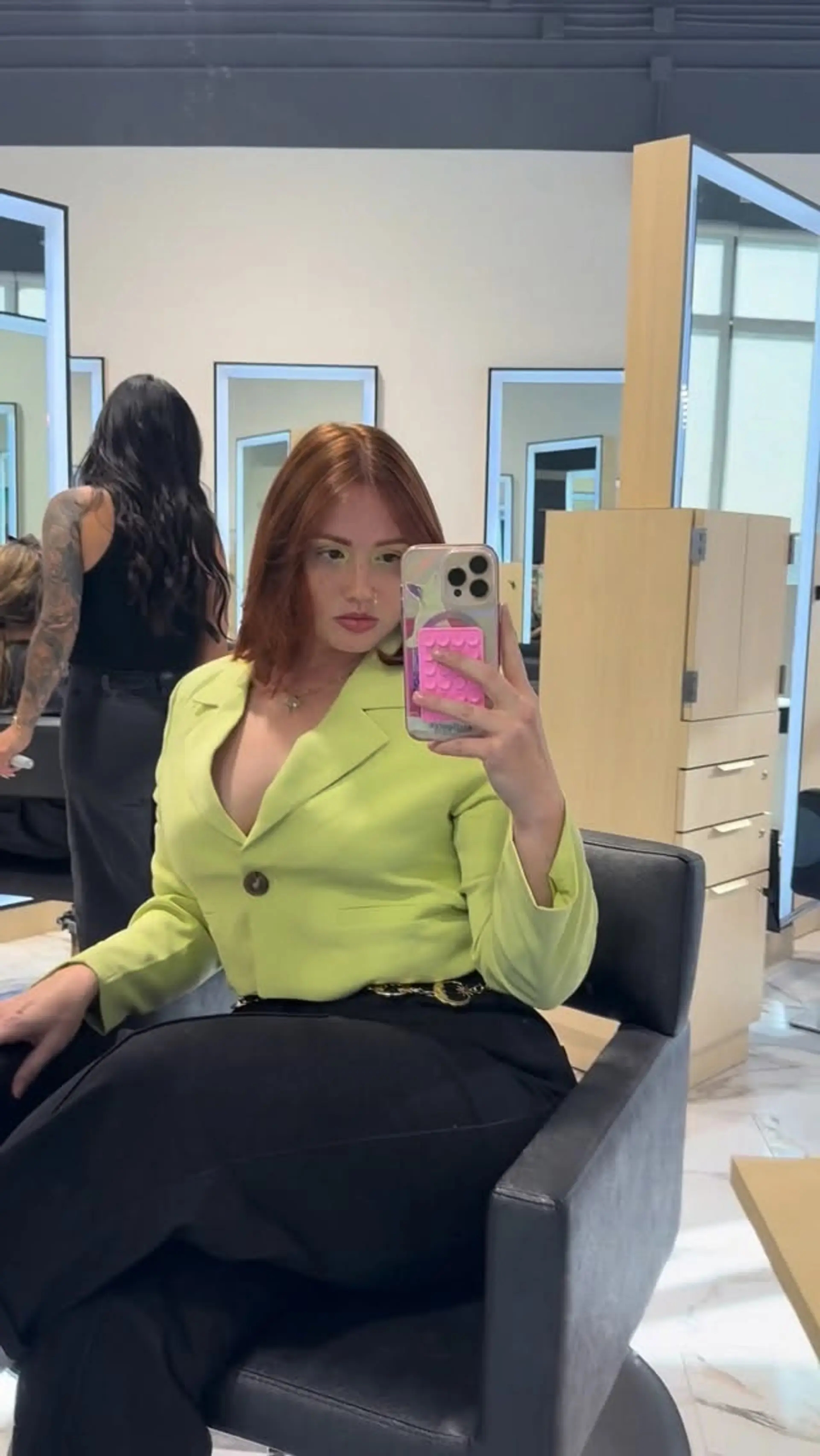 A sleek shoulder-length cut in a vibrant copper red tone styled straight with a center part. 1