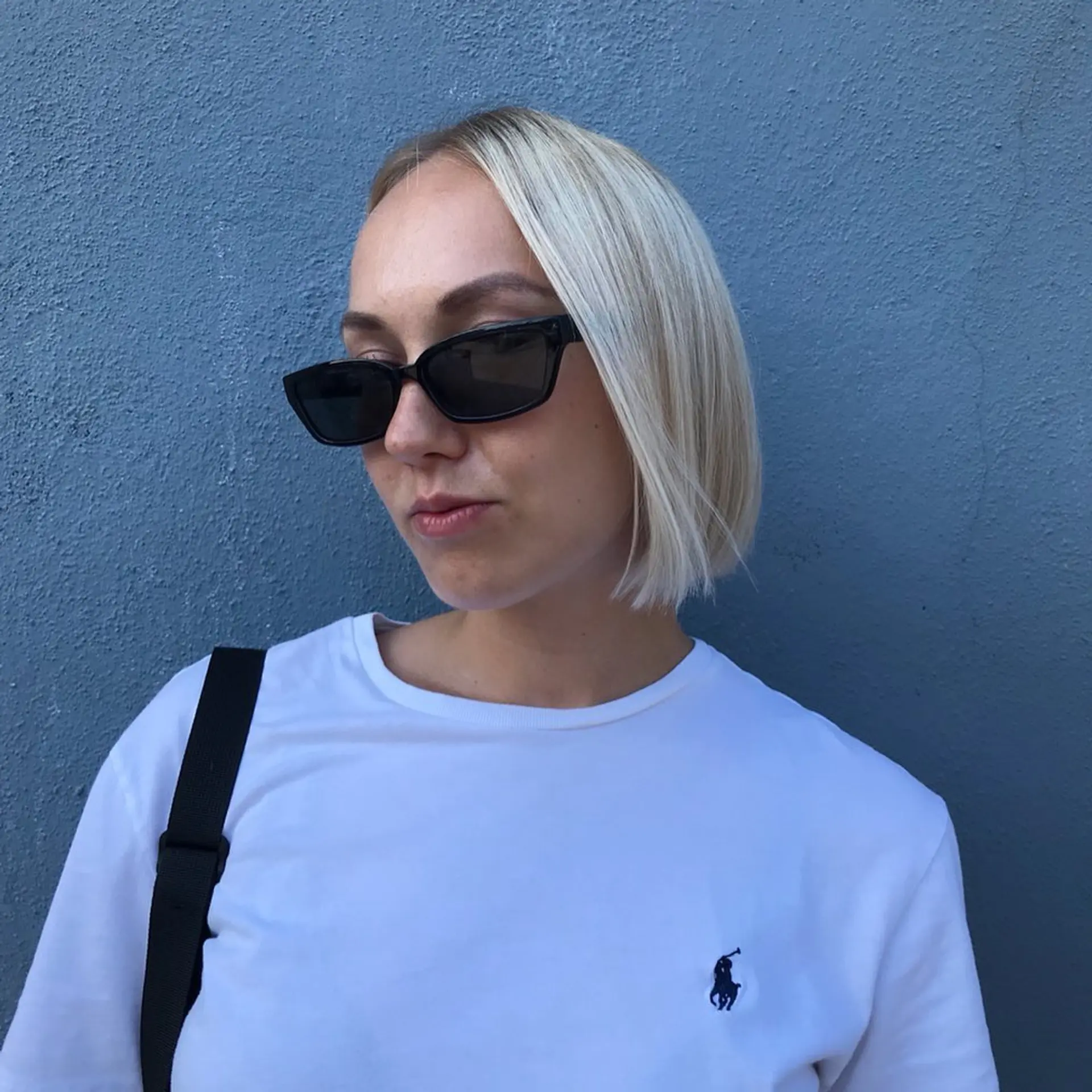 Medium-length platinum blonde straight hair in a classic blunt bob with a glossy finish and a subtle side part. 2