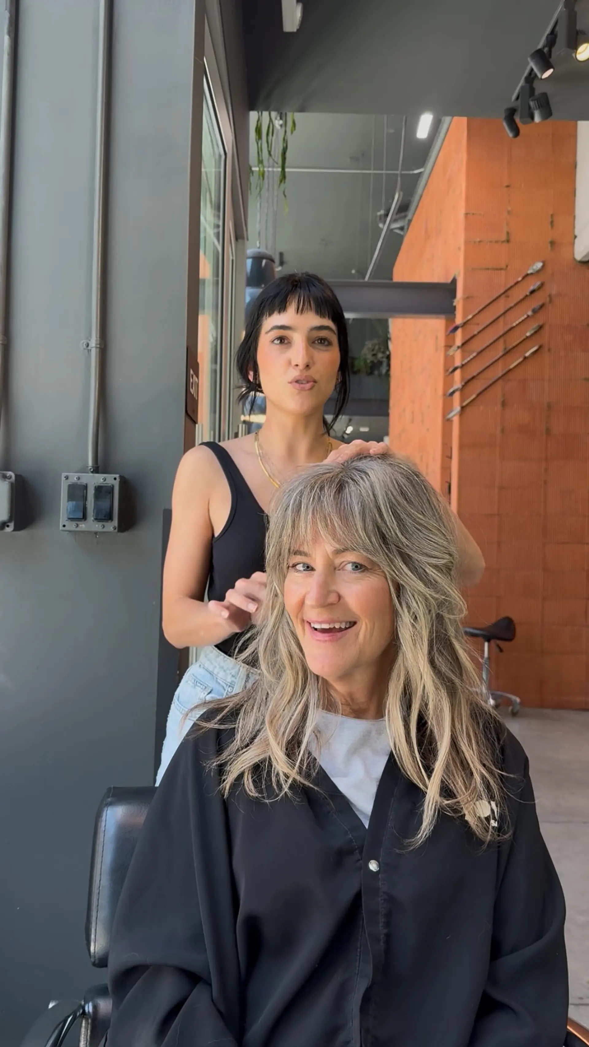 A textured layered shag haircut with fringe bangs and soft grey blending highlights. 1