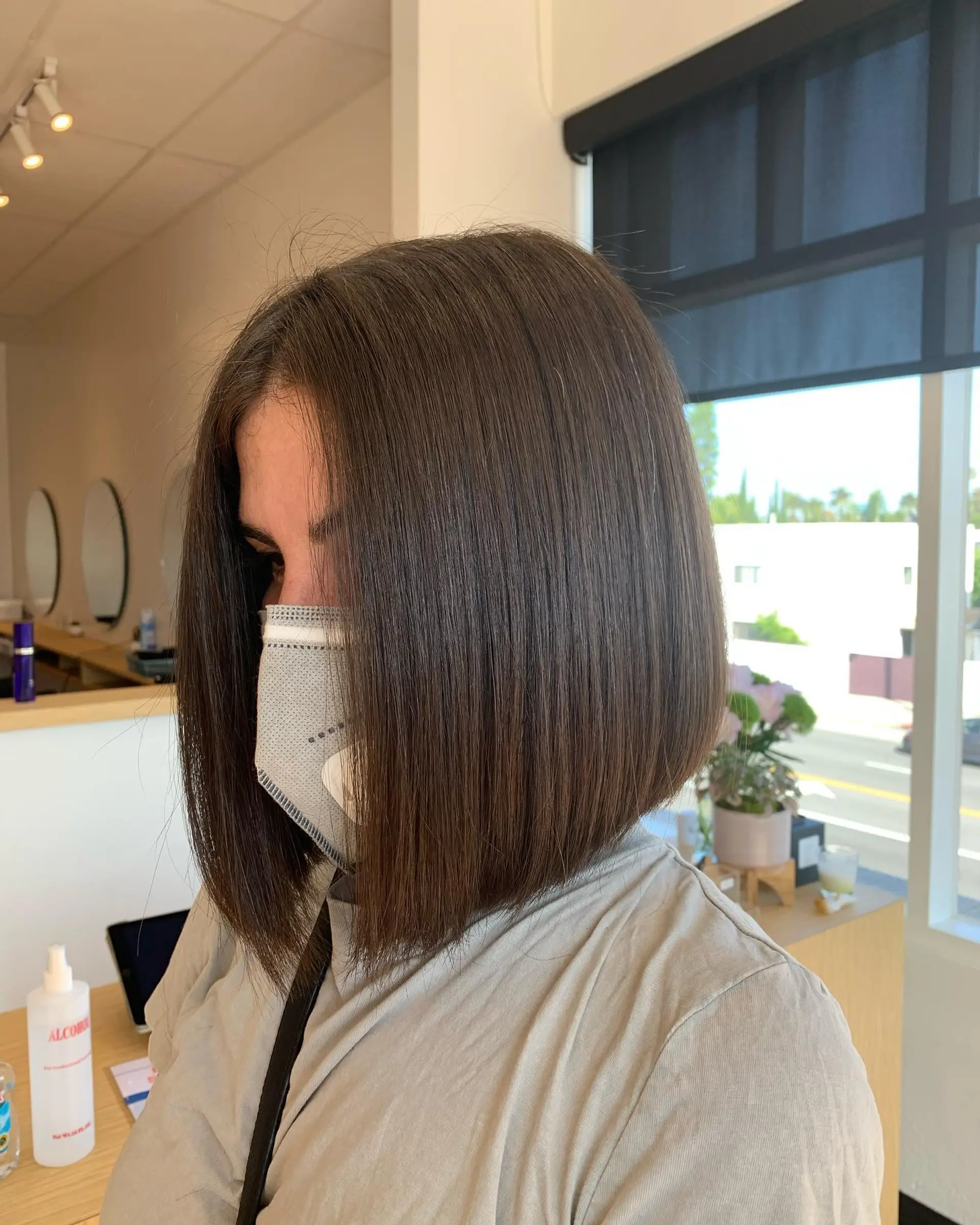 A sleek, precision-cut angled bob in a rich dark brunette tone. 1