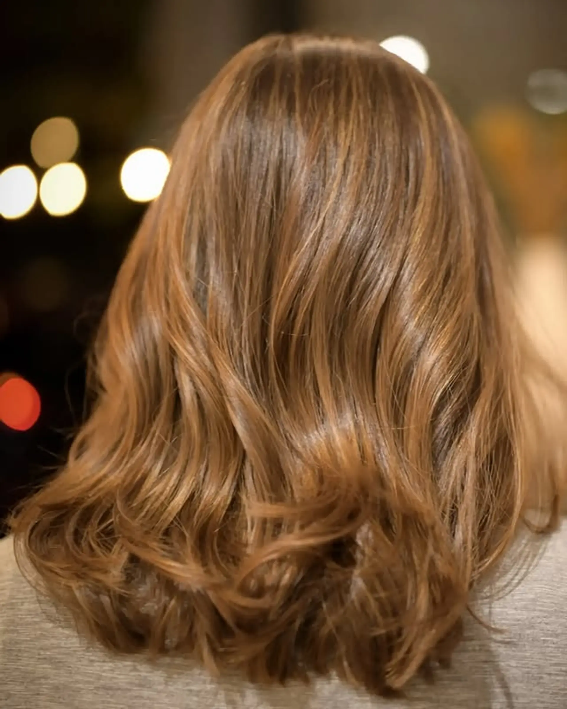 Wavy shoulder-length hair with a soft, natural wave pattern and subtle layering for movement. 1