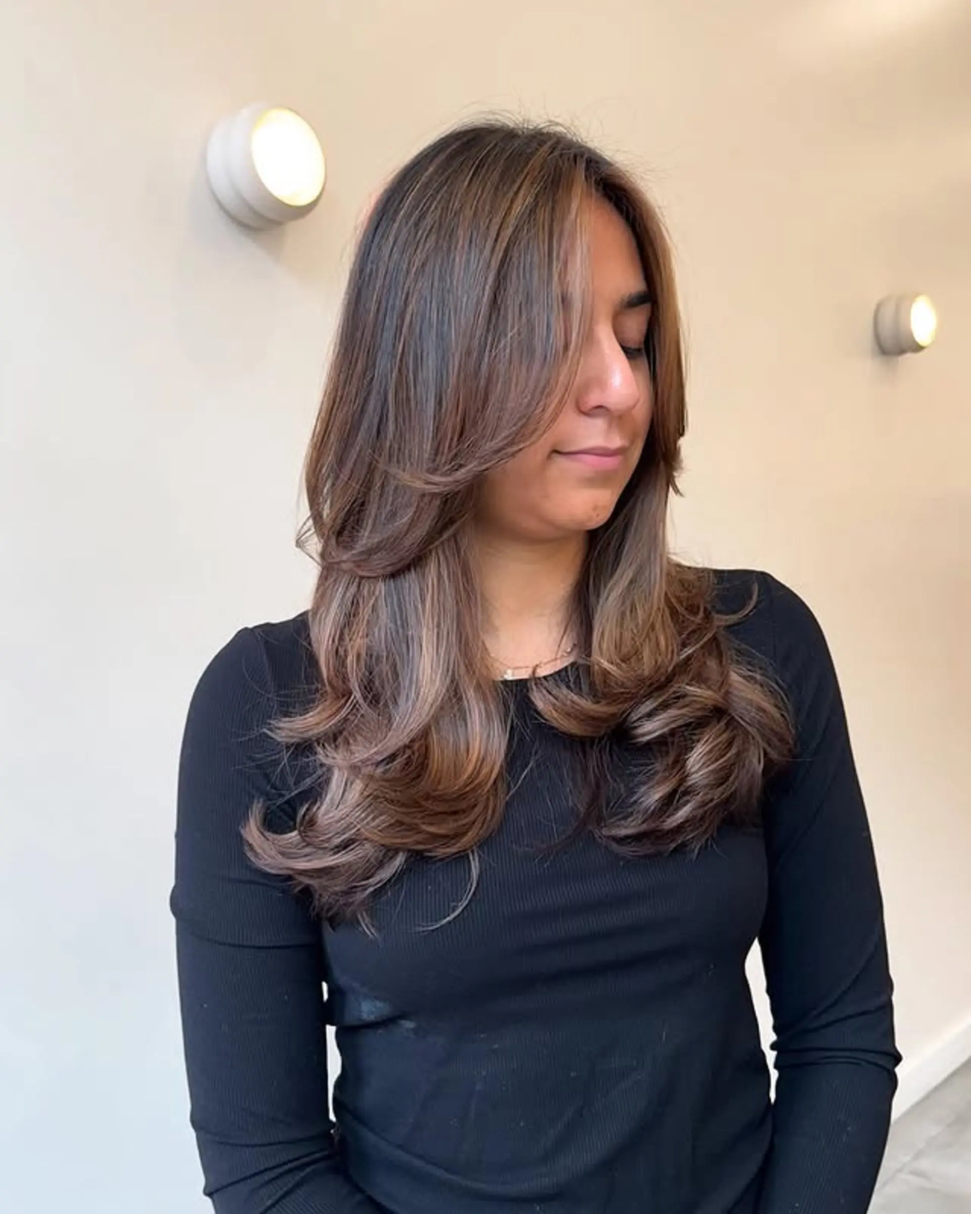 Long, layered wavy hair with face-framing. 1