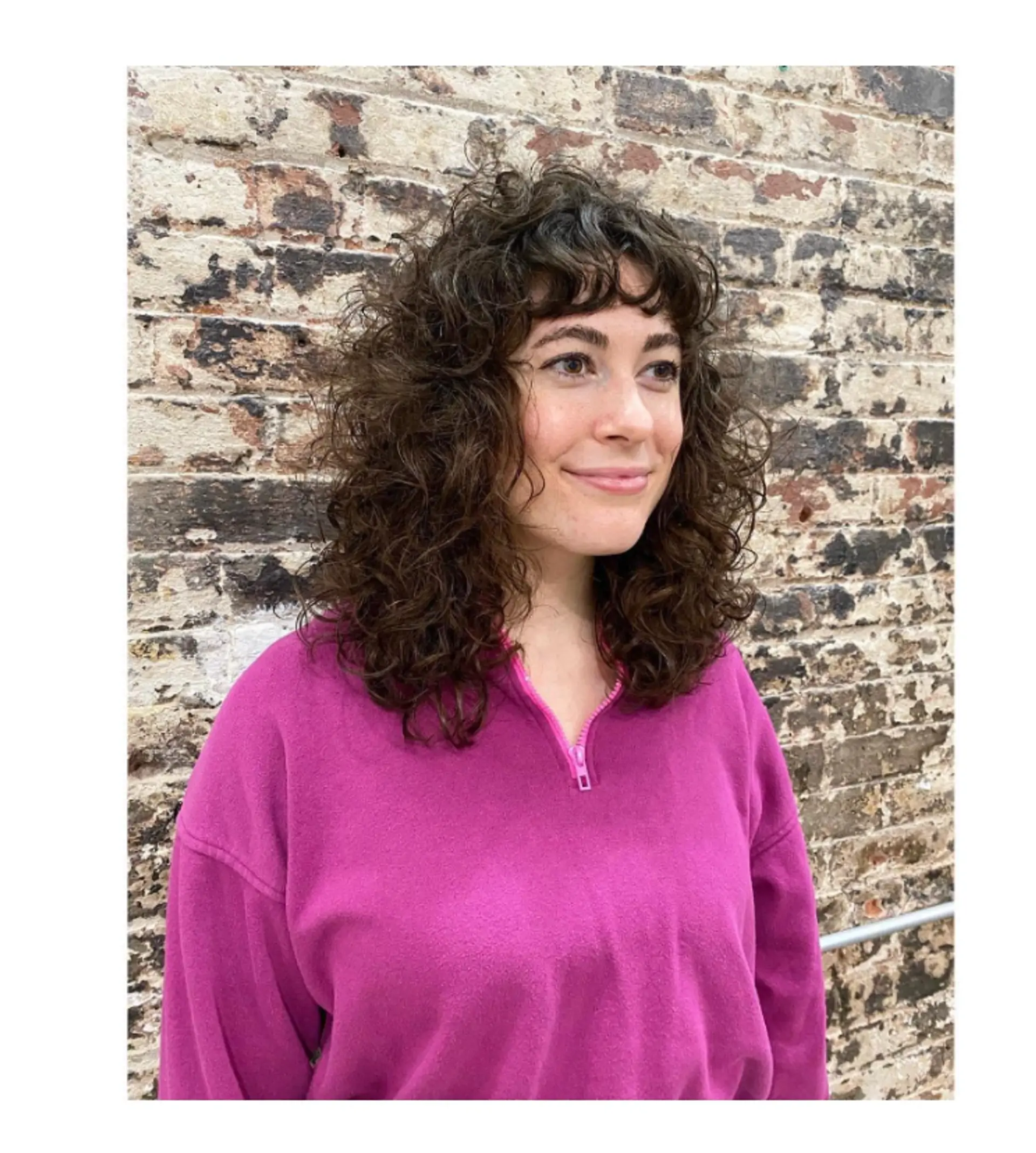 A trendy and modern shag haircut featuring natural curls and face-framing fringe bangs. 1