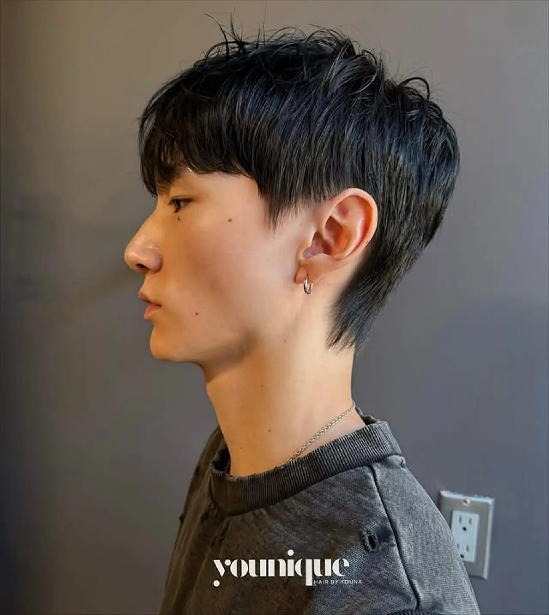 A modern take on the classic mullet, featuring tapered sides, textured top, and a short length. 1