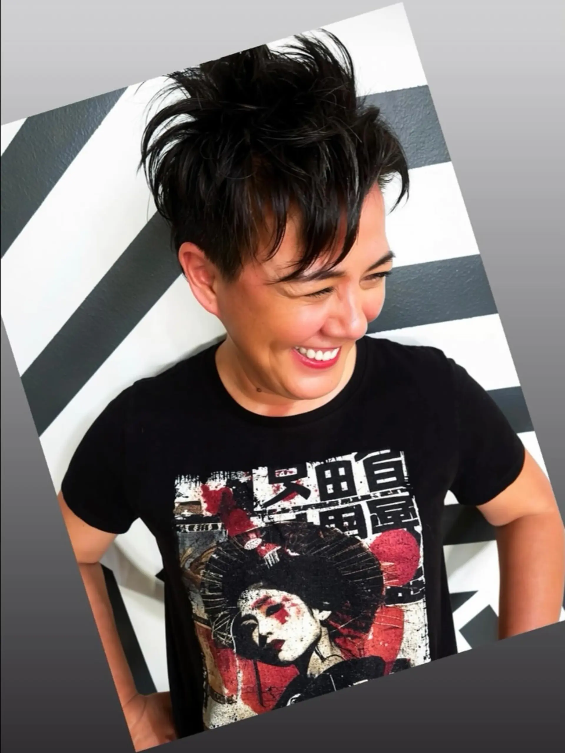 A bold, short pixie cut featuring faded or undercut sides and a high-volume, piecey textured crown swept forward. 1