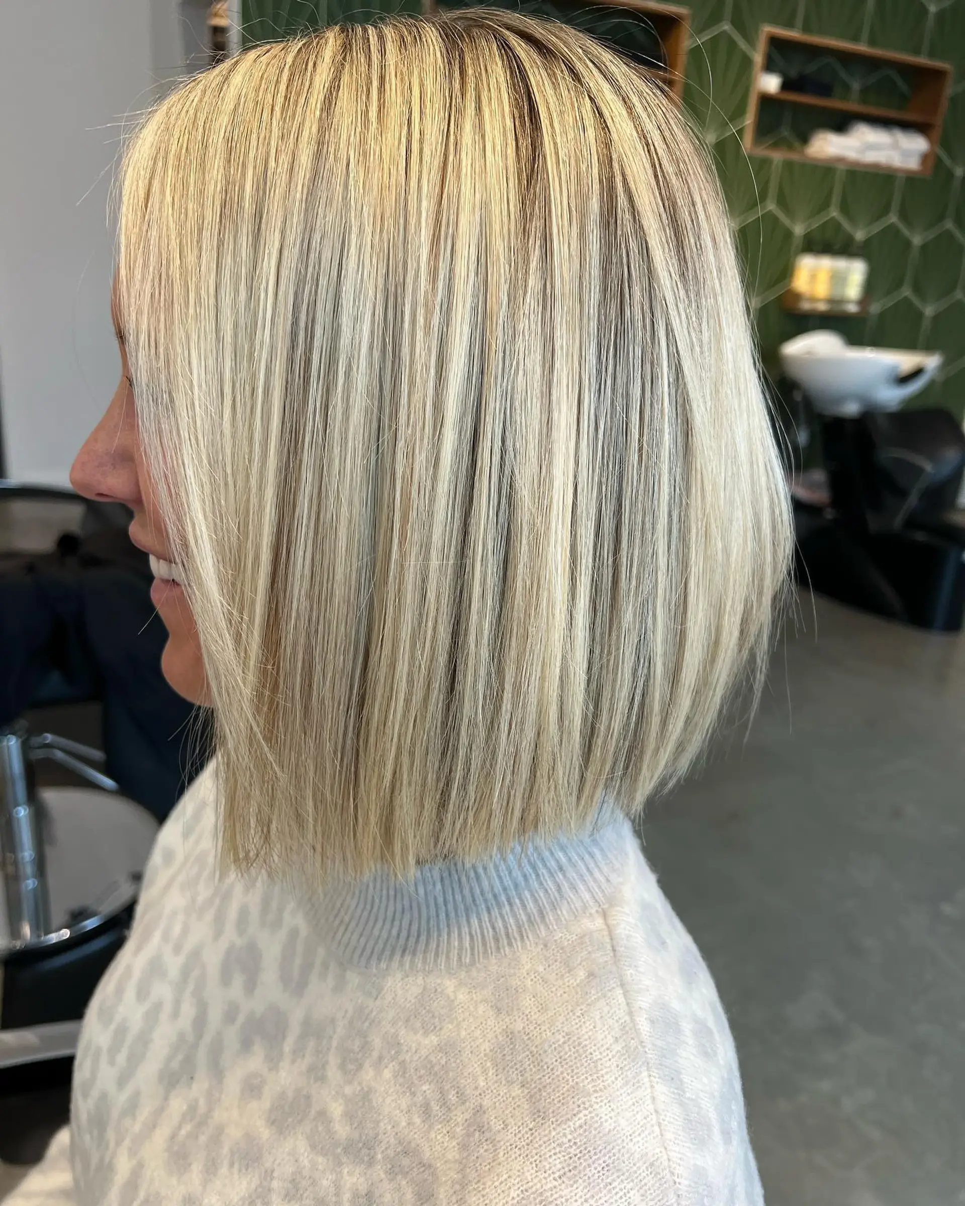 A sleek, straight blunt bob cut at the jawline with multi-dimensional blonde highlights. 1