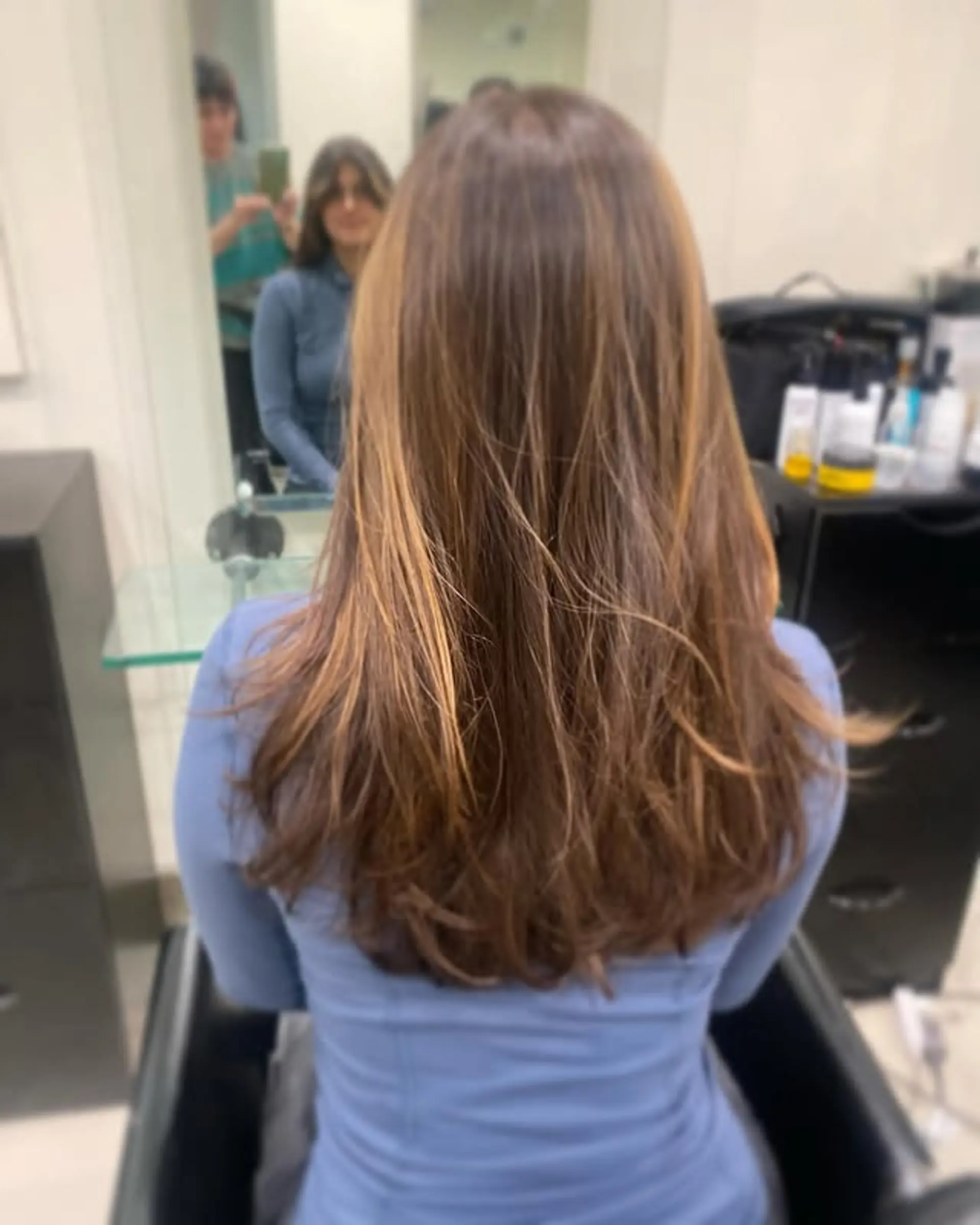Long, straight hair with subtle layers and a bronde balayage. 1