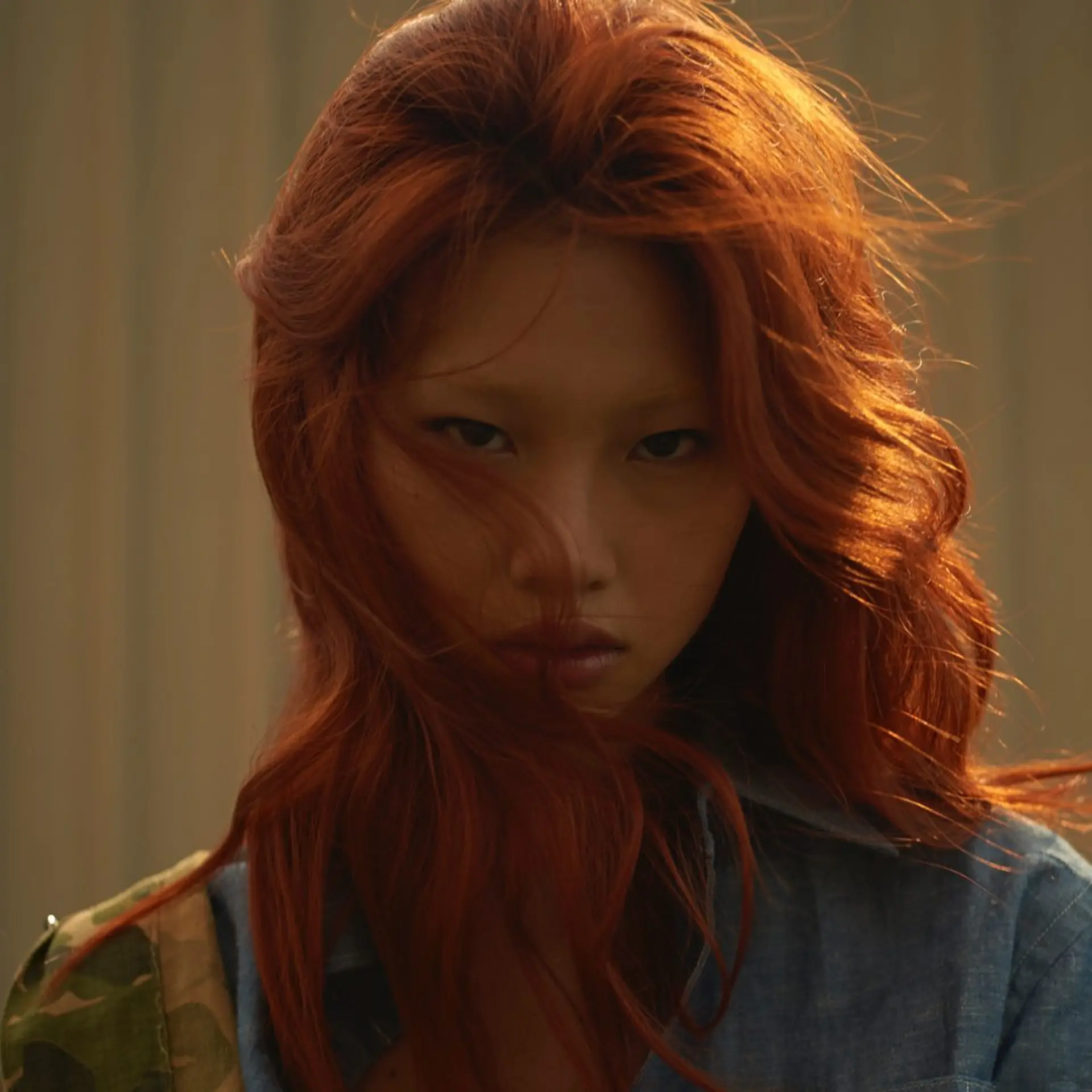 Vibrant copper-red hair styled into loose, voluminous, windblown waves. 1