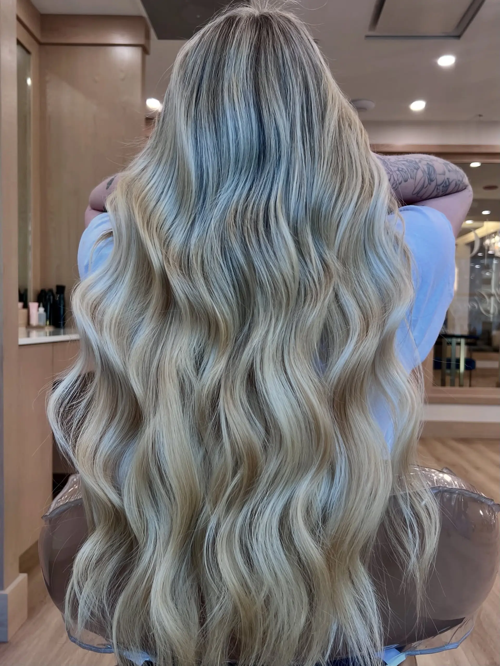 Long, wavy blonde hair styled into soft beach waves. 1