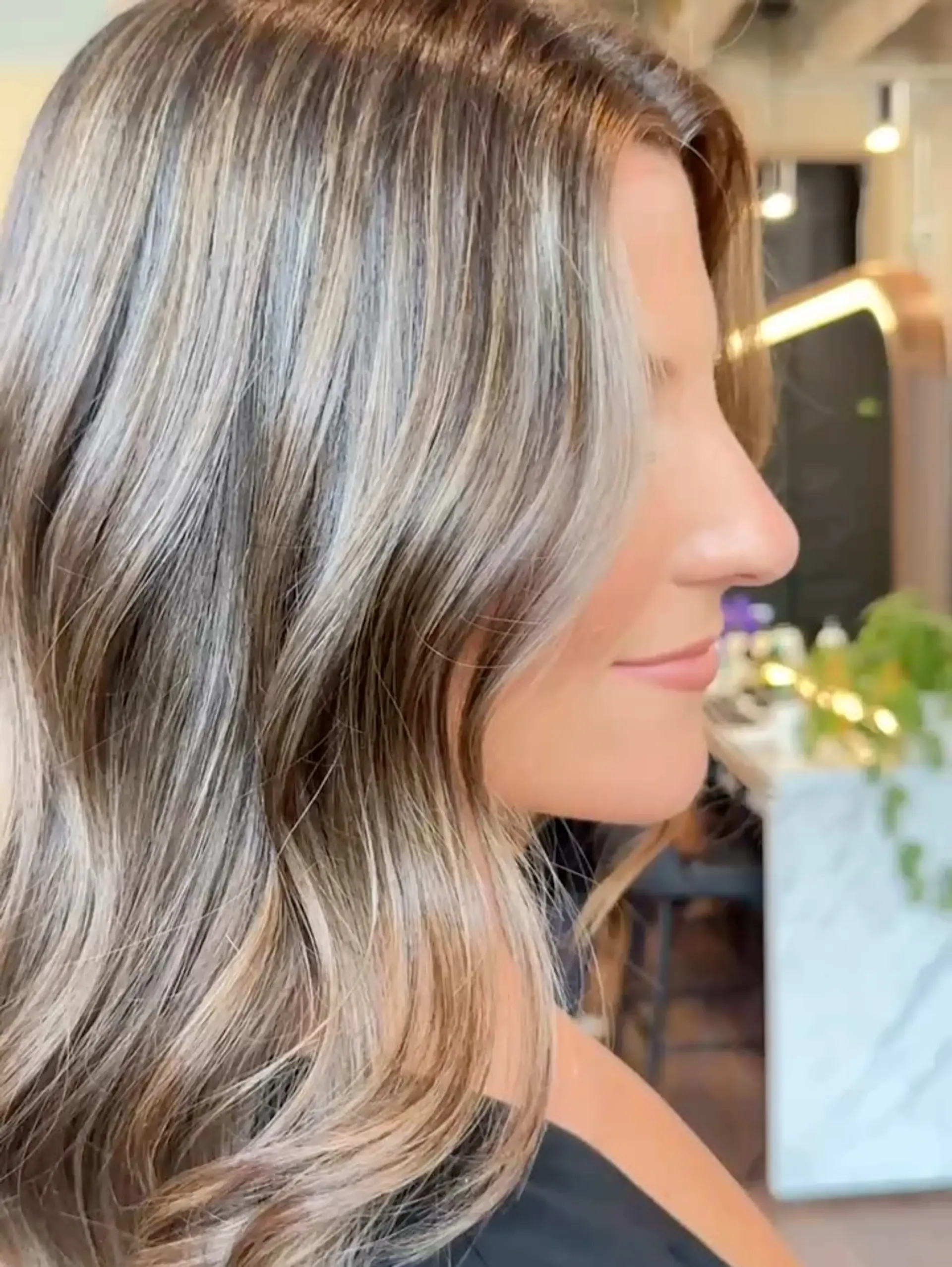 Dimensional brunette balayage styled into soft, natural waves. 1