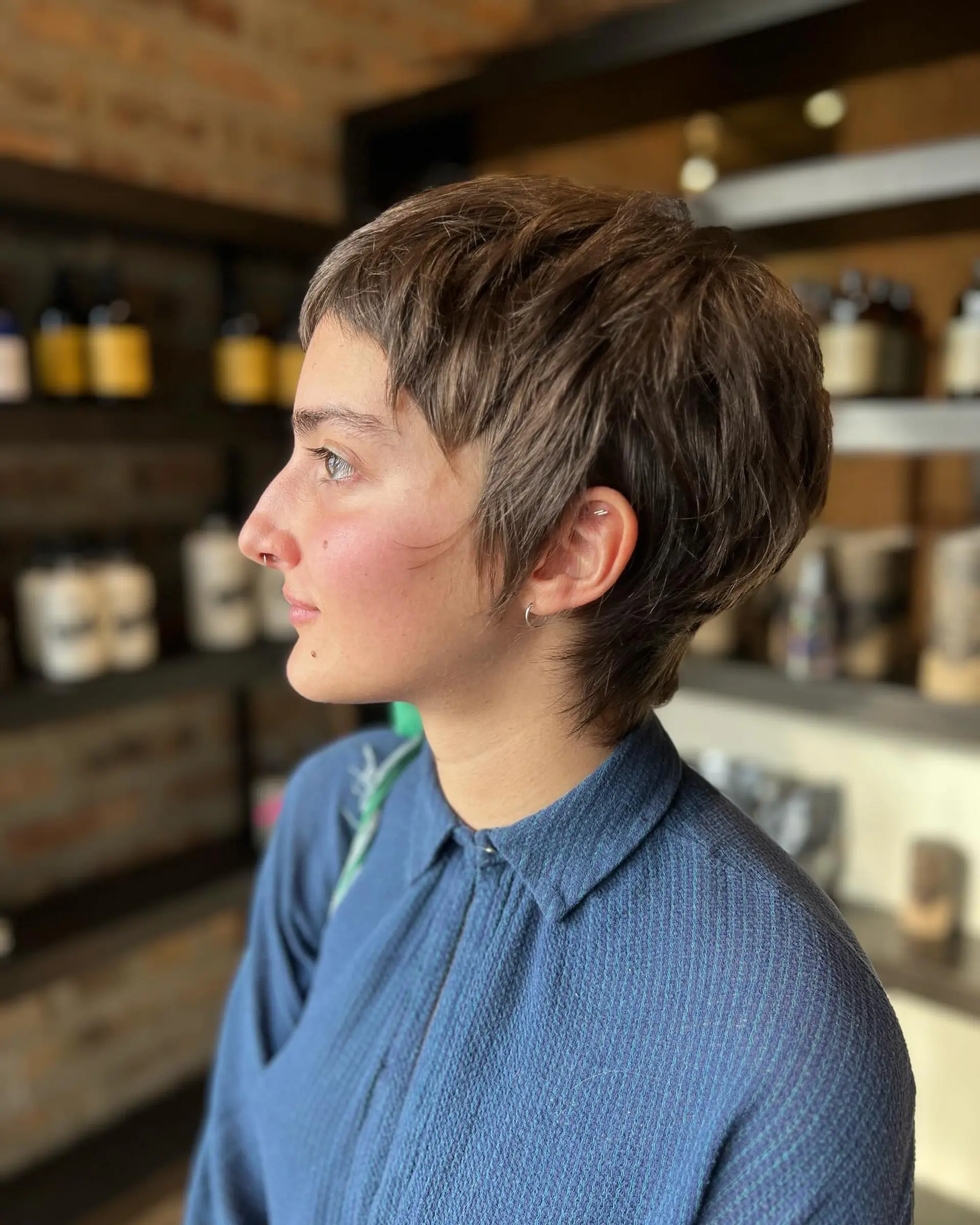 A short, textured pixie cut with choppy layers. 1