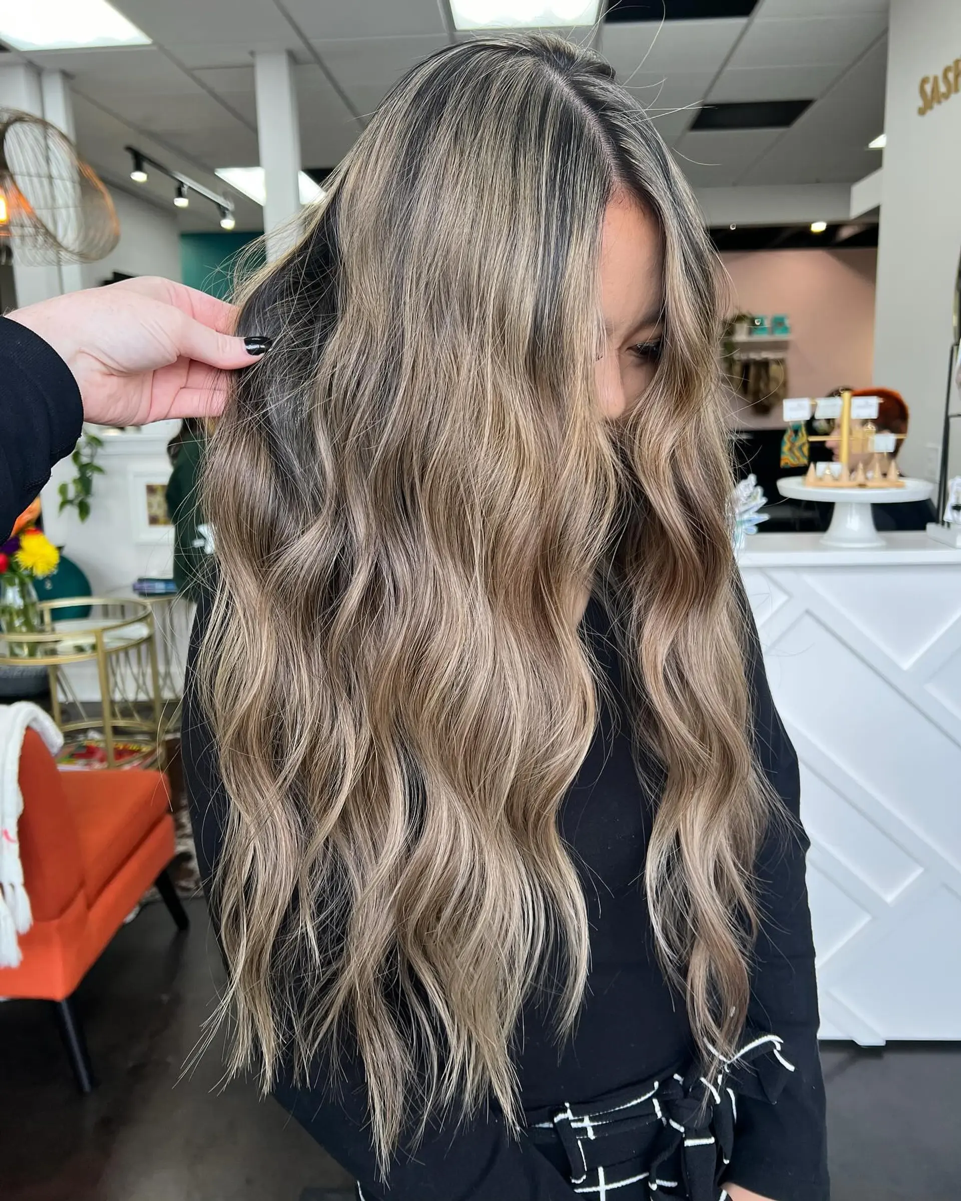 Extra-long dimensional ash blonde balayage styled in loose, lived-in waves. 1
