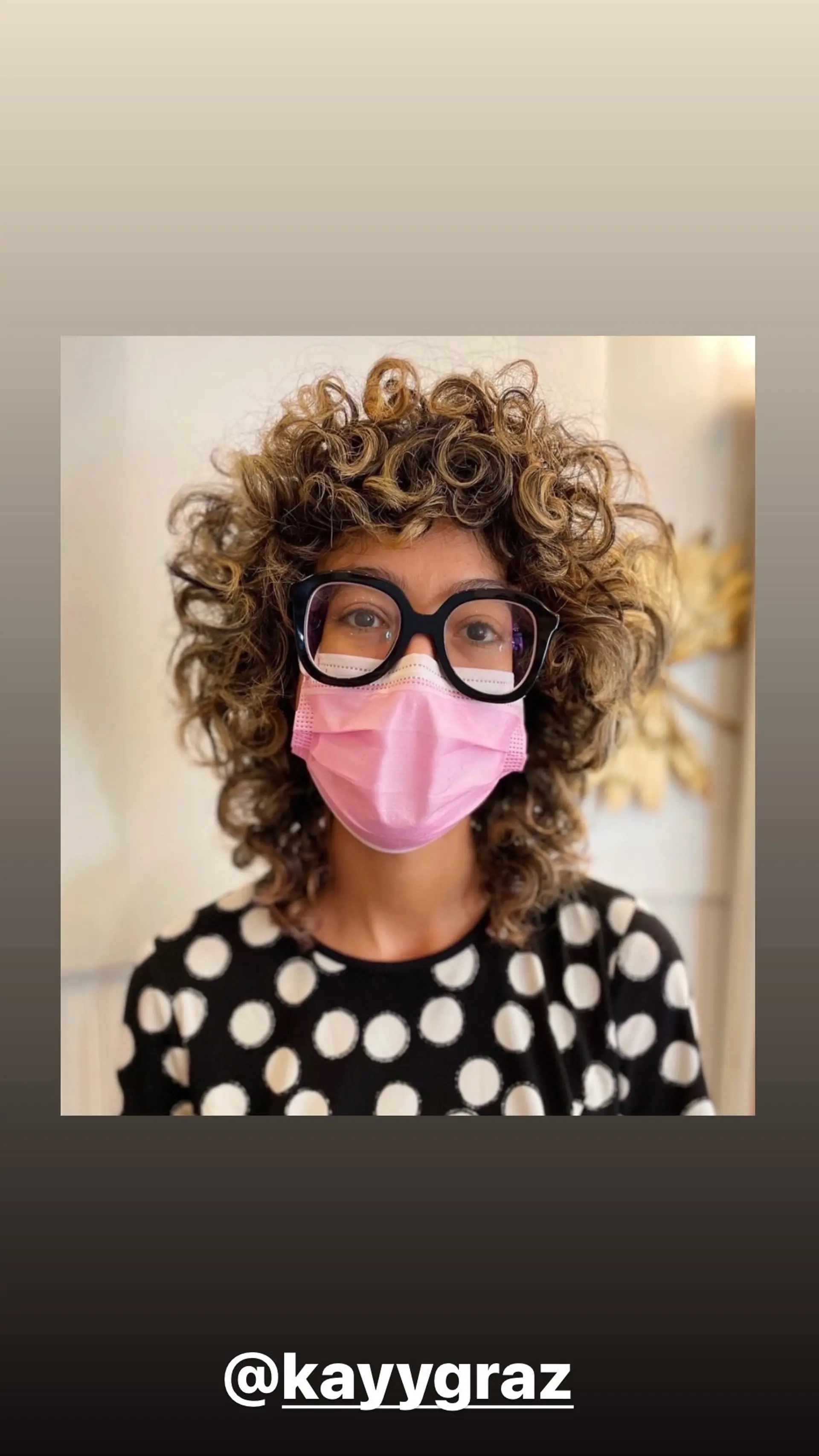 A medium-length curly bob with defined honey blonde highlights. 1