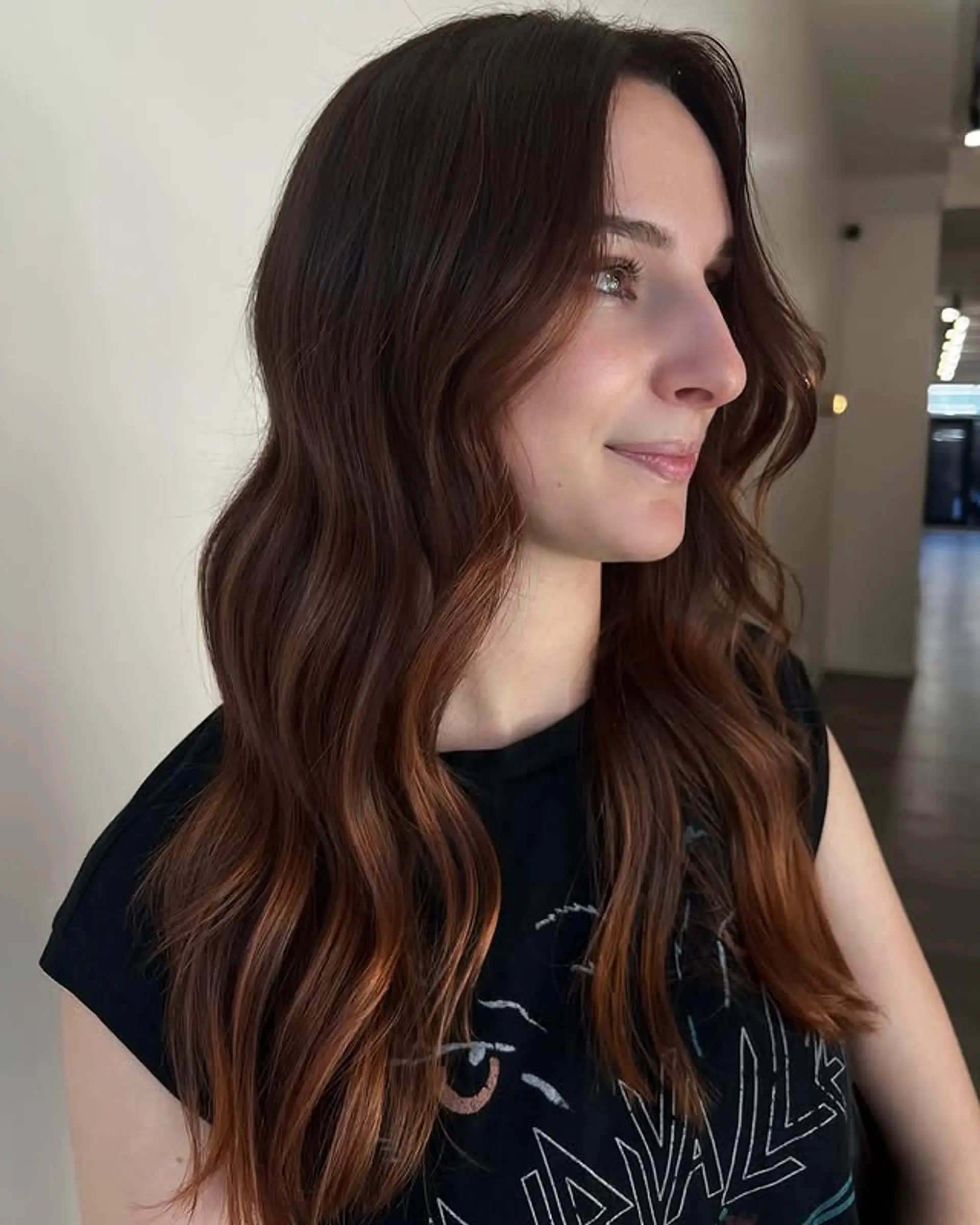 Long, wavy brunette hair with subtle bronzed auburn highlights. 1
