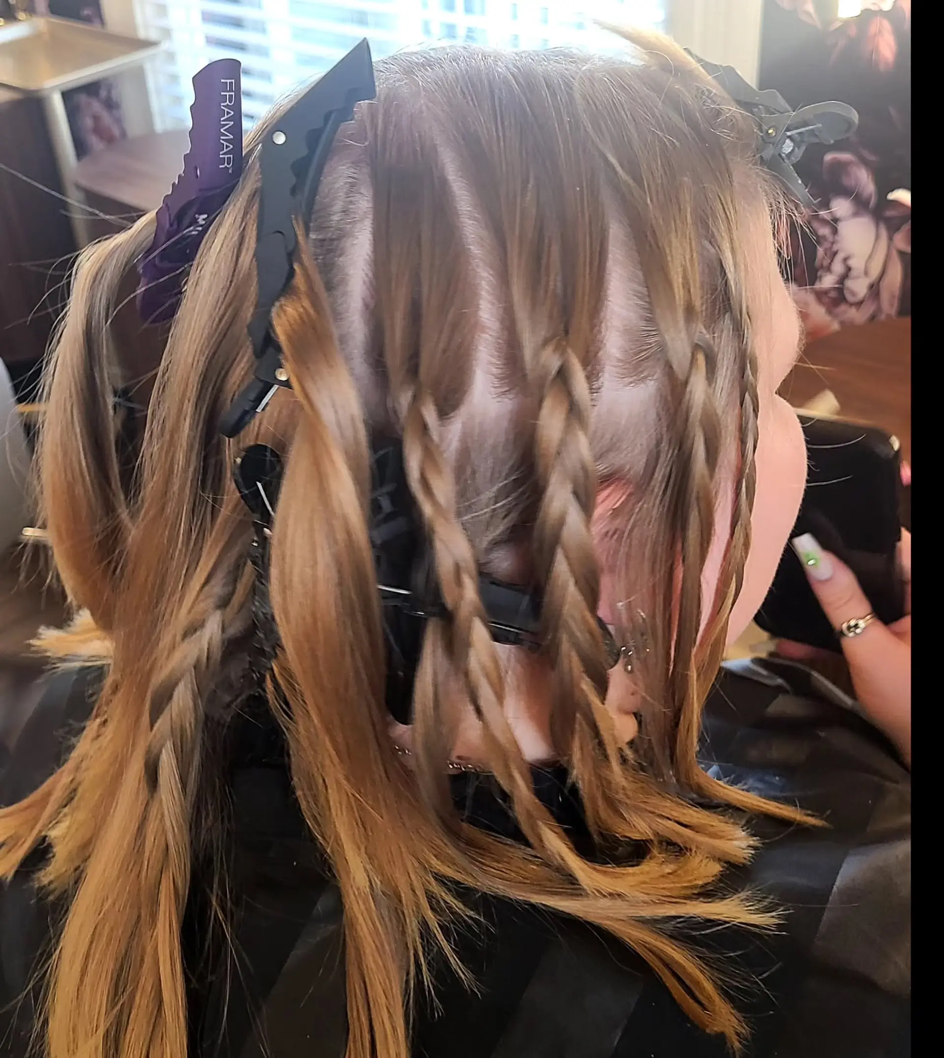 A medium-length, straight hairstyle showcasing a dynamic multi-tonal color palette. It features a blend of natural base colors with bold vivid pink, magenta, and lavender highlights, styled with a chic half-up messy bun. 5