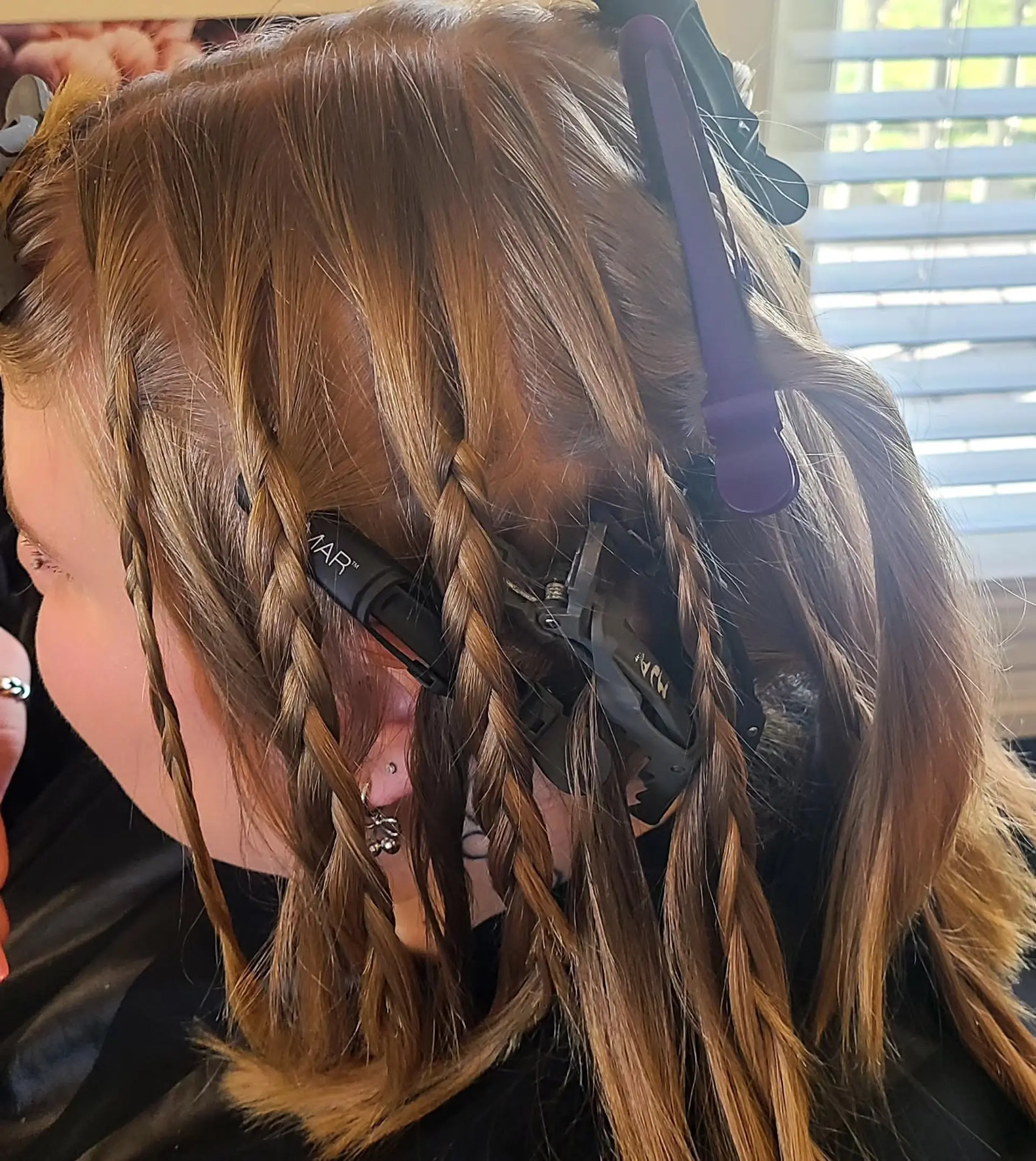 A medium-length, straight hairstyle showcasing a dynamic multi-tonal color palette. It features a blend of natural base colors with bold vivid pink, magenta, and lavender highlights, styled with a chic half-up messy bun. 6