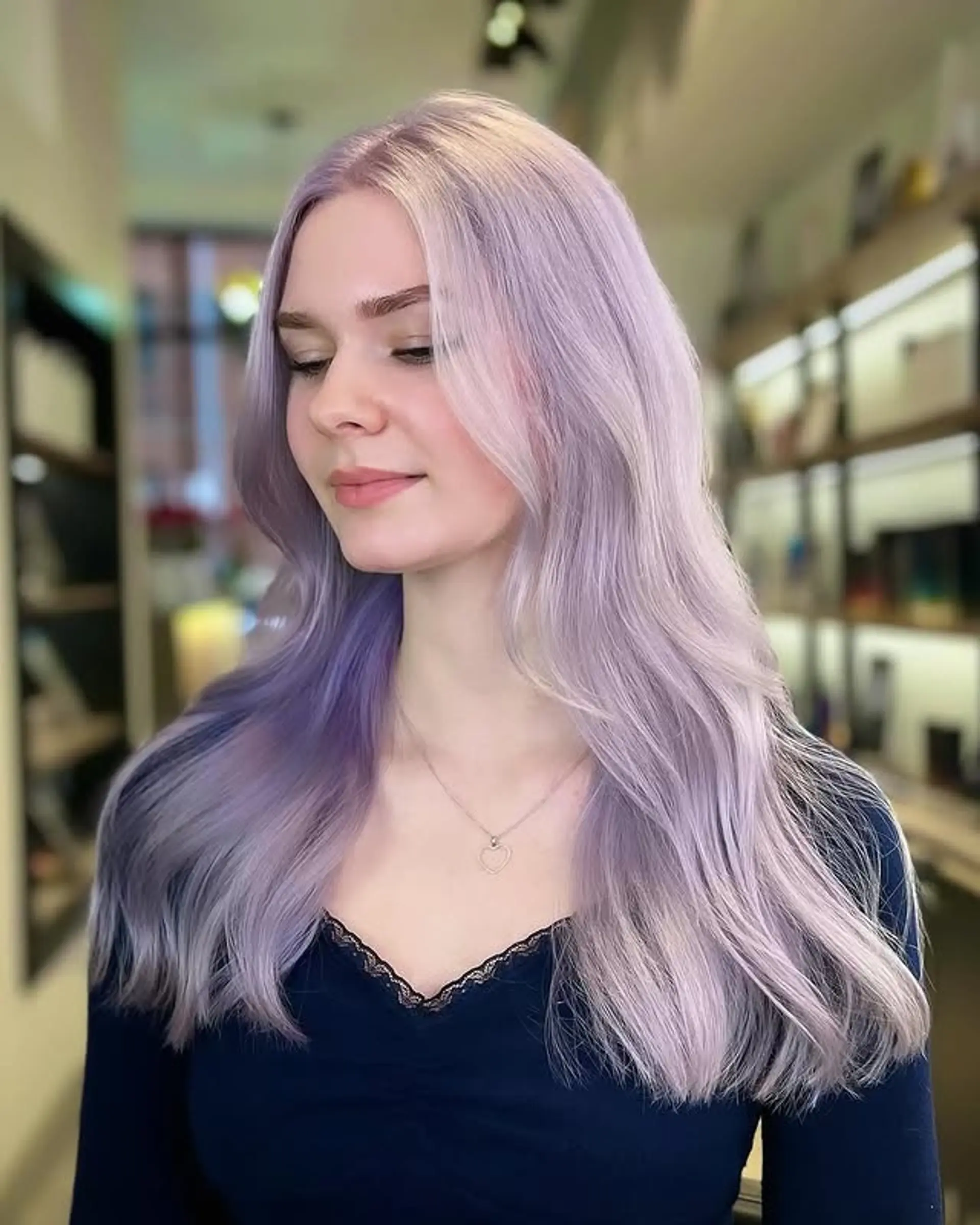Long, layered wavy hair with a vibrant lilac color. 1