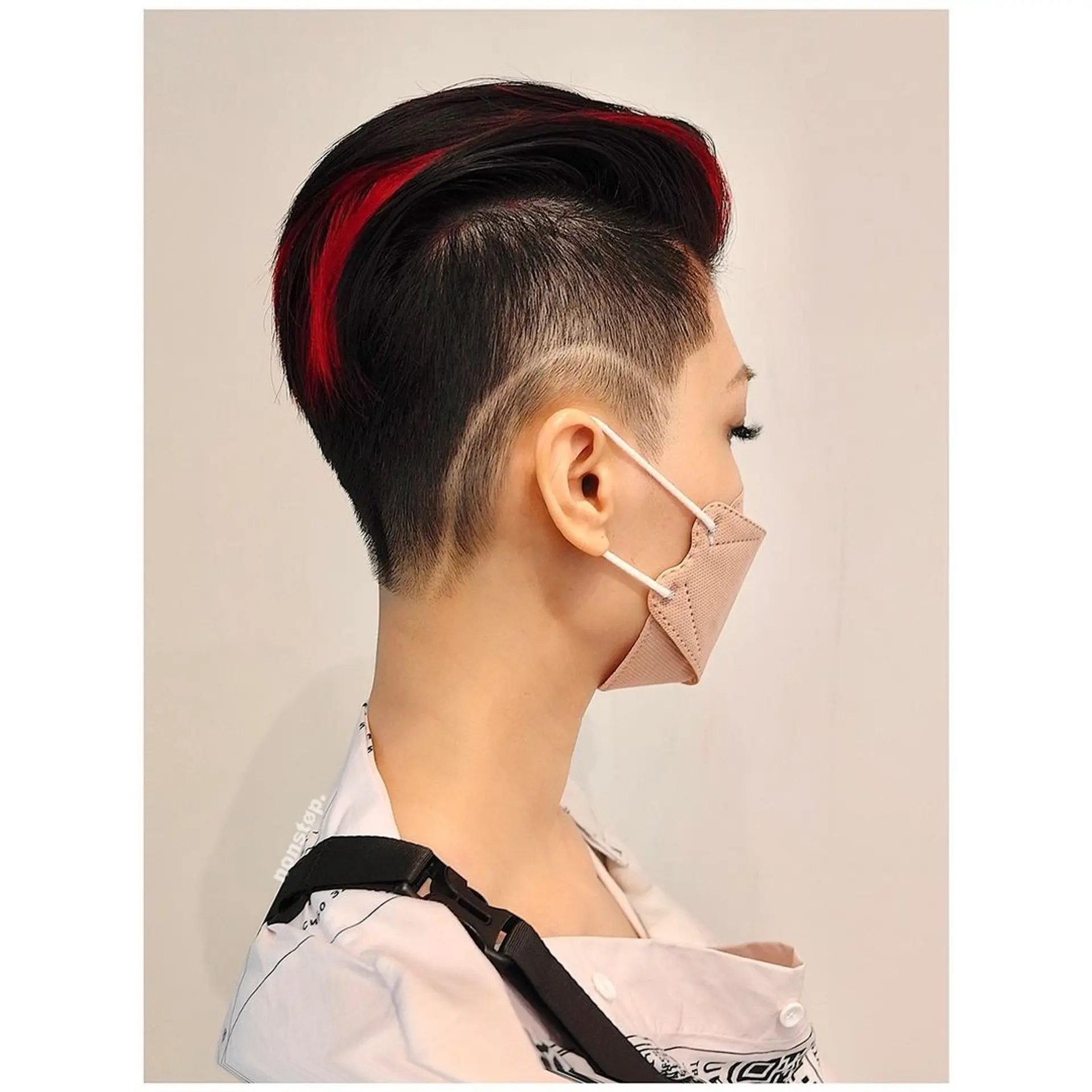 A striking and edgy hairstyle featuring a sharp undercut with closely cropped sides and a longer, voluminous top. It is predominantly black with vivid, crimson red streaks, offering a sleek, modern look with an asymmetrical design. 🩸Hair by HIRO🩸 2