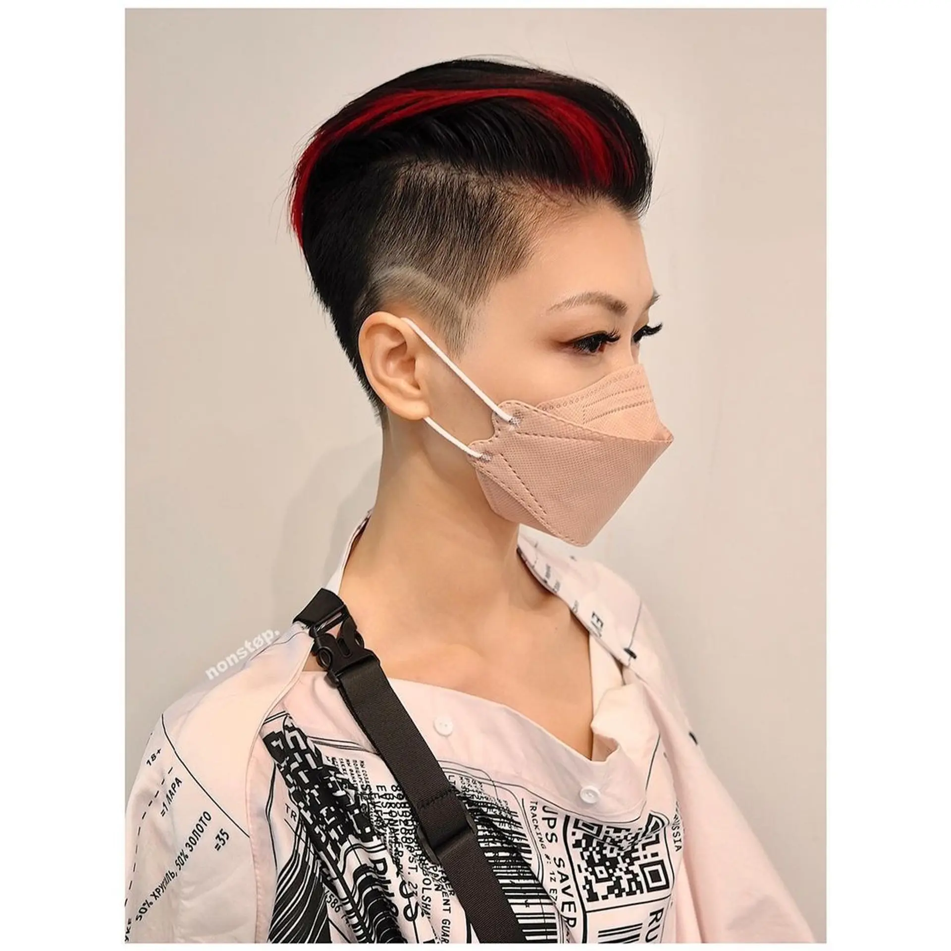 A striking and edgy hairstyle featuring a sharp undercut with closely cropped sides and a longer, voluminous top. It is predominantly black with vivid, crimson red streaks, offering a sleek, modern look with an asymmetrical design. 🩸Hair by HIRO🩸 1