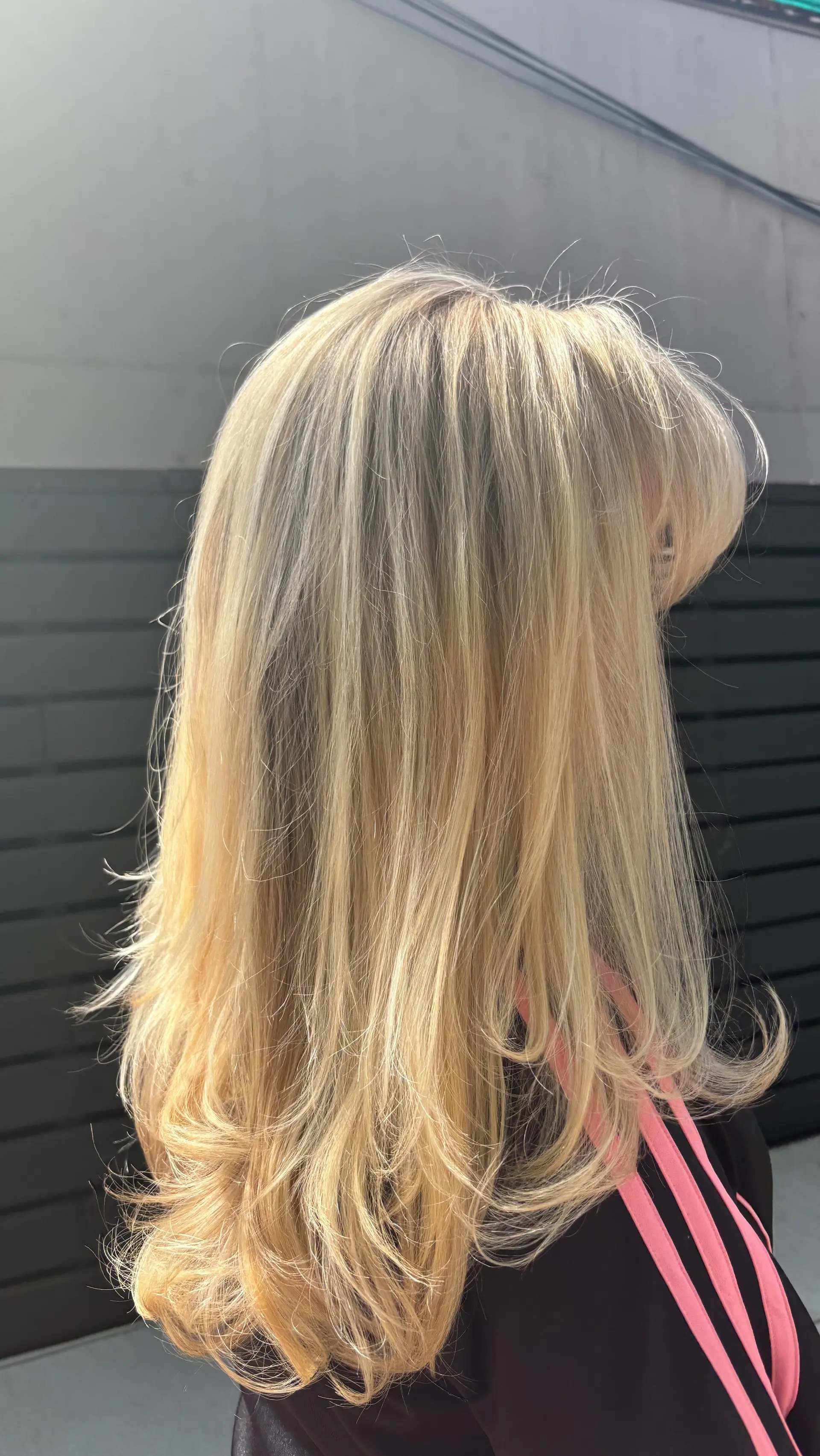 A voluminous layered blonde blowout with flipped ends and face-framing layers. 1