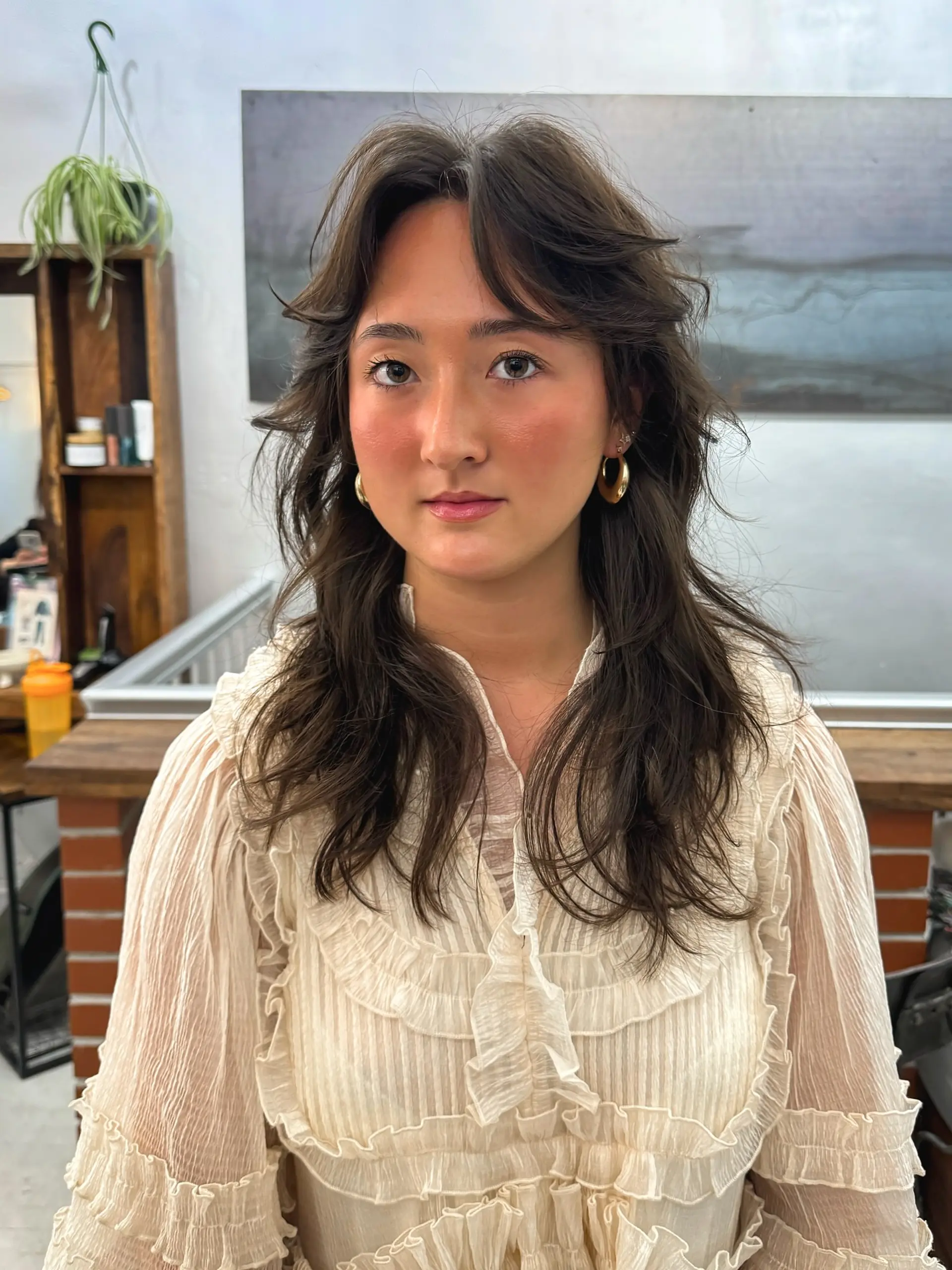 A modern shag haircut with textured layers and face-framing curtain bangs. 1