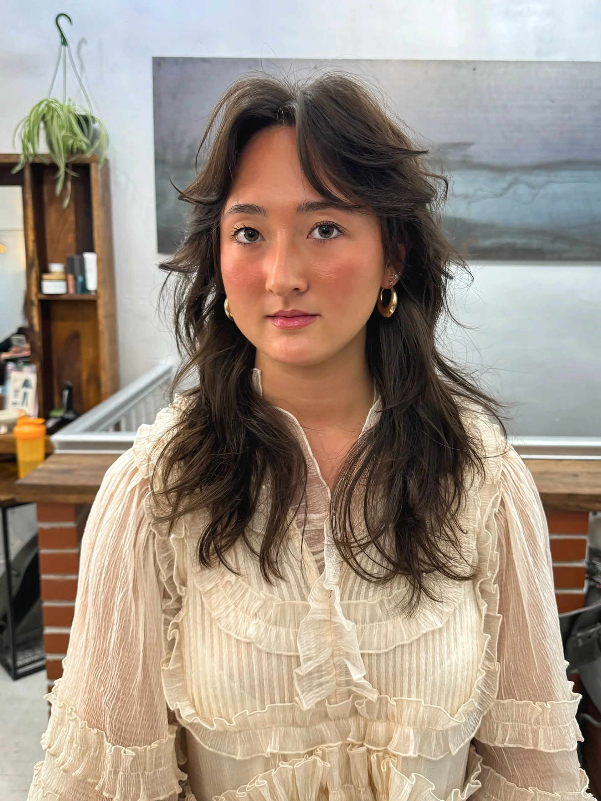 Trendy modern shag haircut with curtain bangs and textured layers in a New York City salon - Preview 1