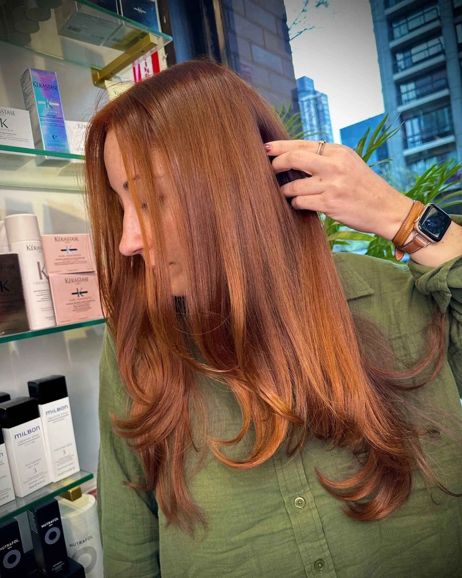 Long, sleek, straight copper-red hair with layers and a side part, creating a soft, feathered look. 1