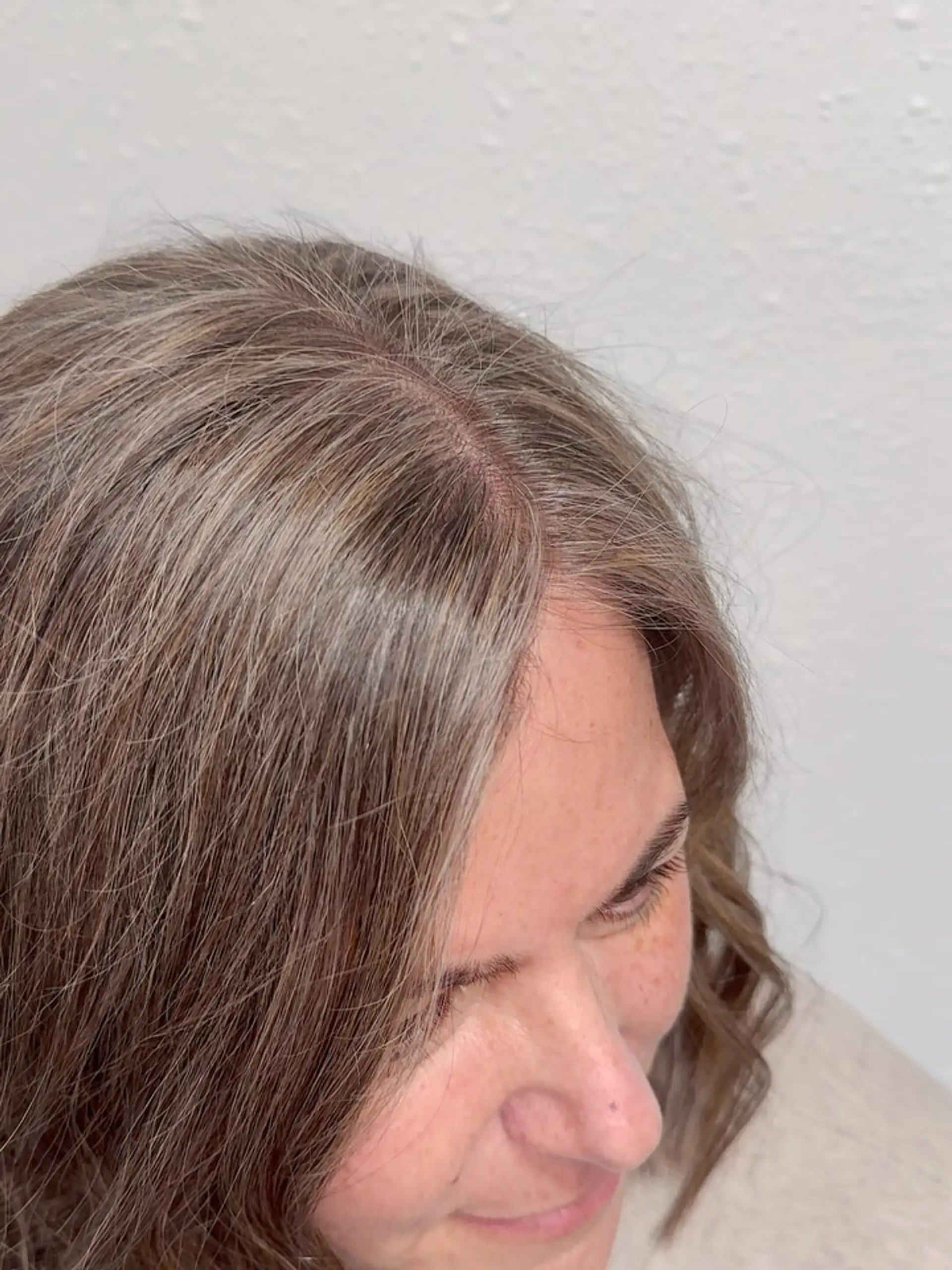 Natural gray blending using delicate babylights and demi-permanent root color on medium hair. 1